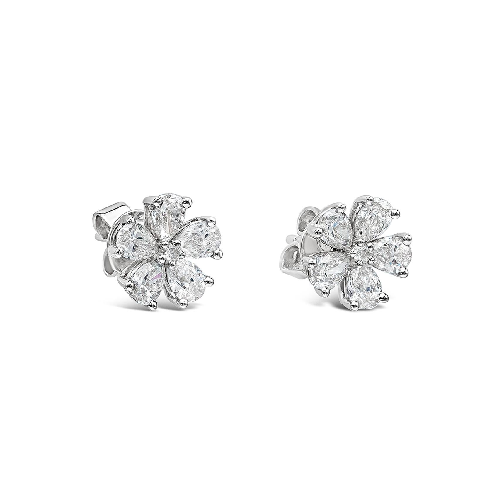 A very beautiful pair of stud earrings featuring a round brilliant diamond center, accented with brilliant pear shape diamonds set in a beautiful loral-motif design. Made in 18k white gold.

Style available in different price ranges. Prices are