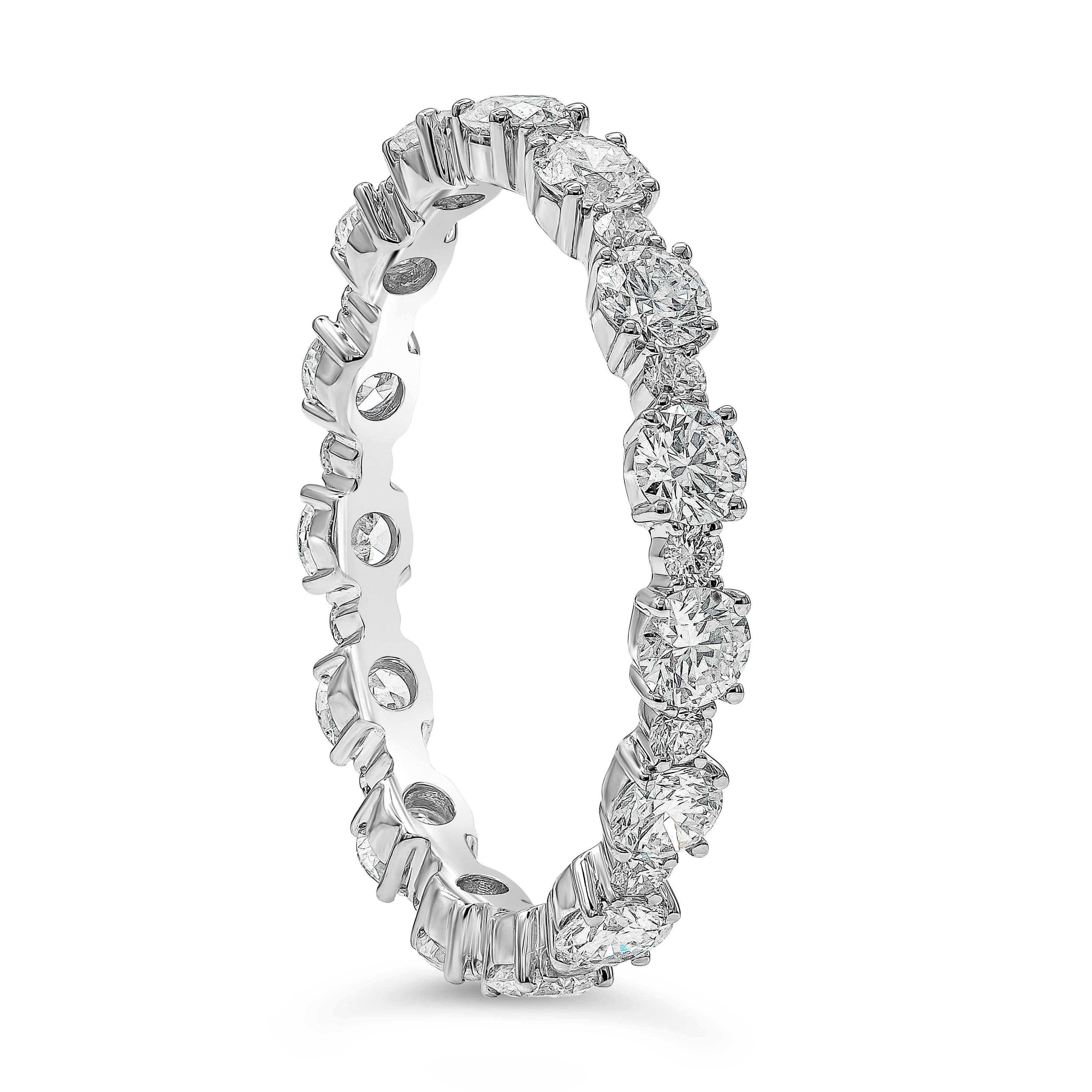 A uniquely-designed eternity wedding band showcasing a row of round brilliant diamonds elegantly spaced by smaller round melee diamonds weigh 1.49 carats total, G Color and VS-SI in Clarity. Made in 18K White Gold, Size 6.5 US resizable upon