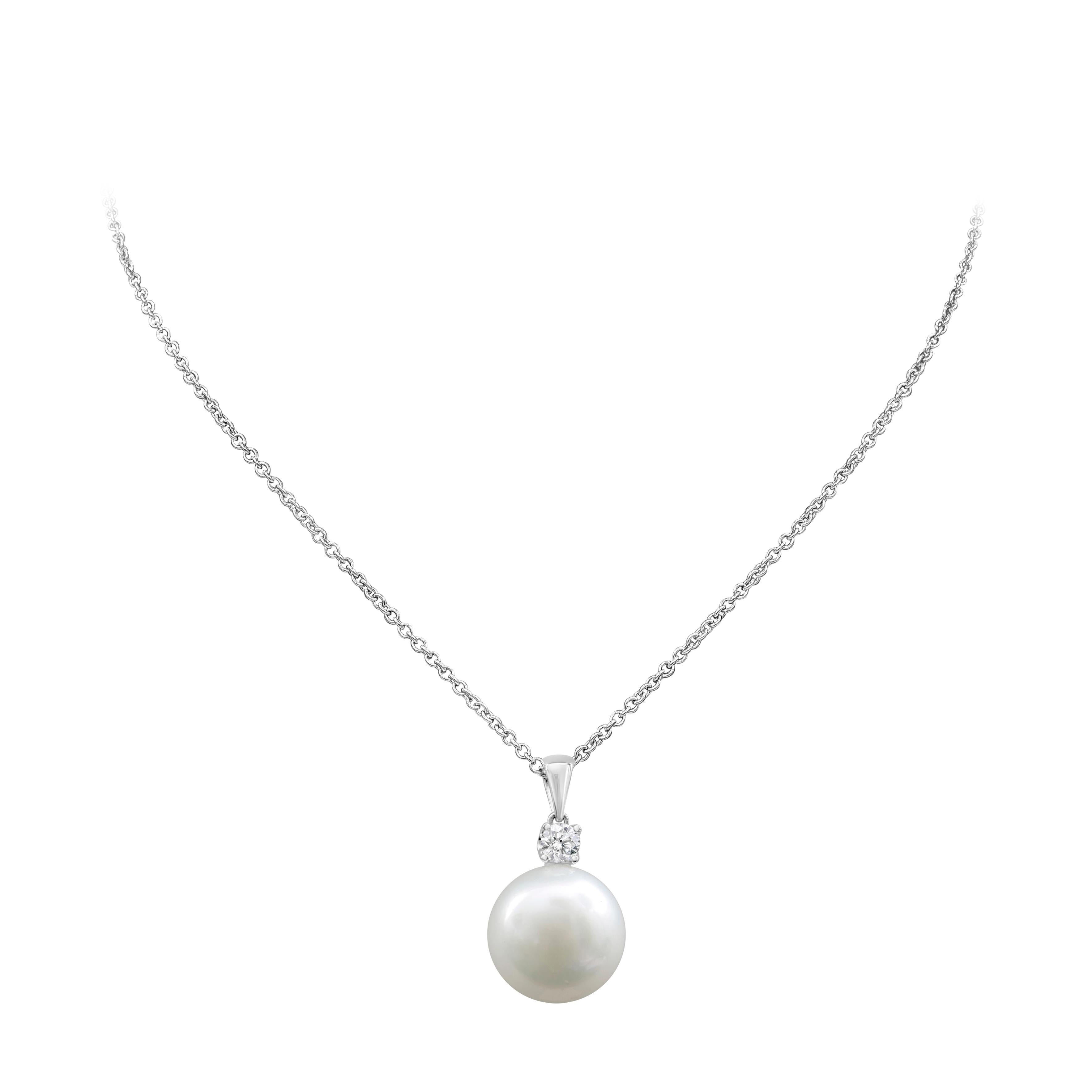 A stylish and attractive pendant necklace showcasing 14mm fine white pearl,  accented with brilliant round shape diamond weighing 0.26 carats, set in a classic four prong setting. Perfectly made in 18k white gold and suspended on an 18 inch