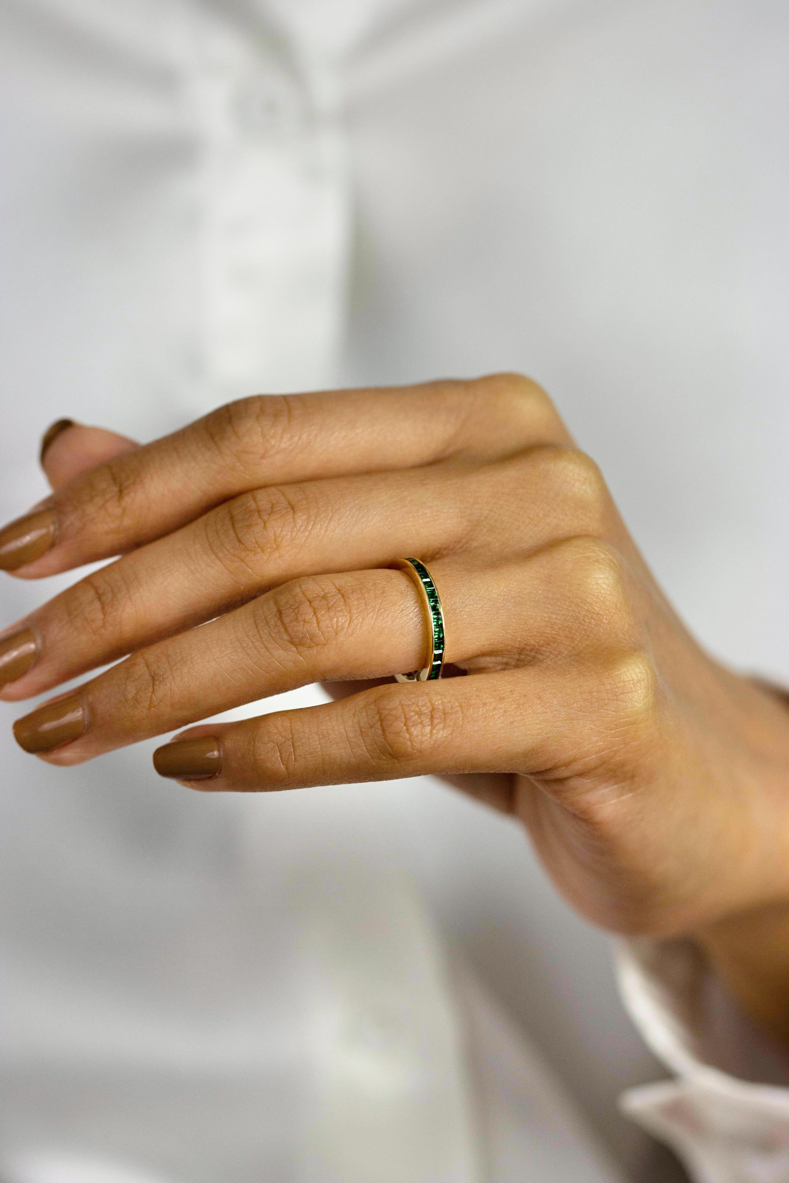 A gorgeous eternity wedding band ring featuring square cut emerald-green tsavorite weighing 1.50 carats total. Channel set, Made in 14K Yellow Gold, Size 6 US resizable upon request.

Style available in different price ranges. Prices are based on