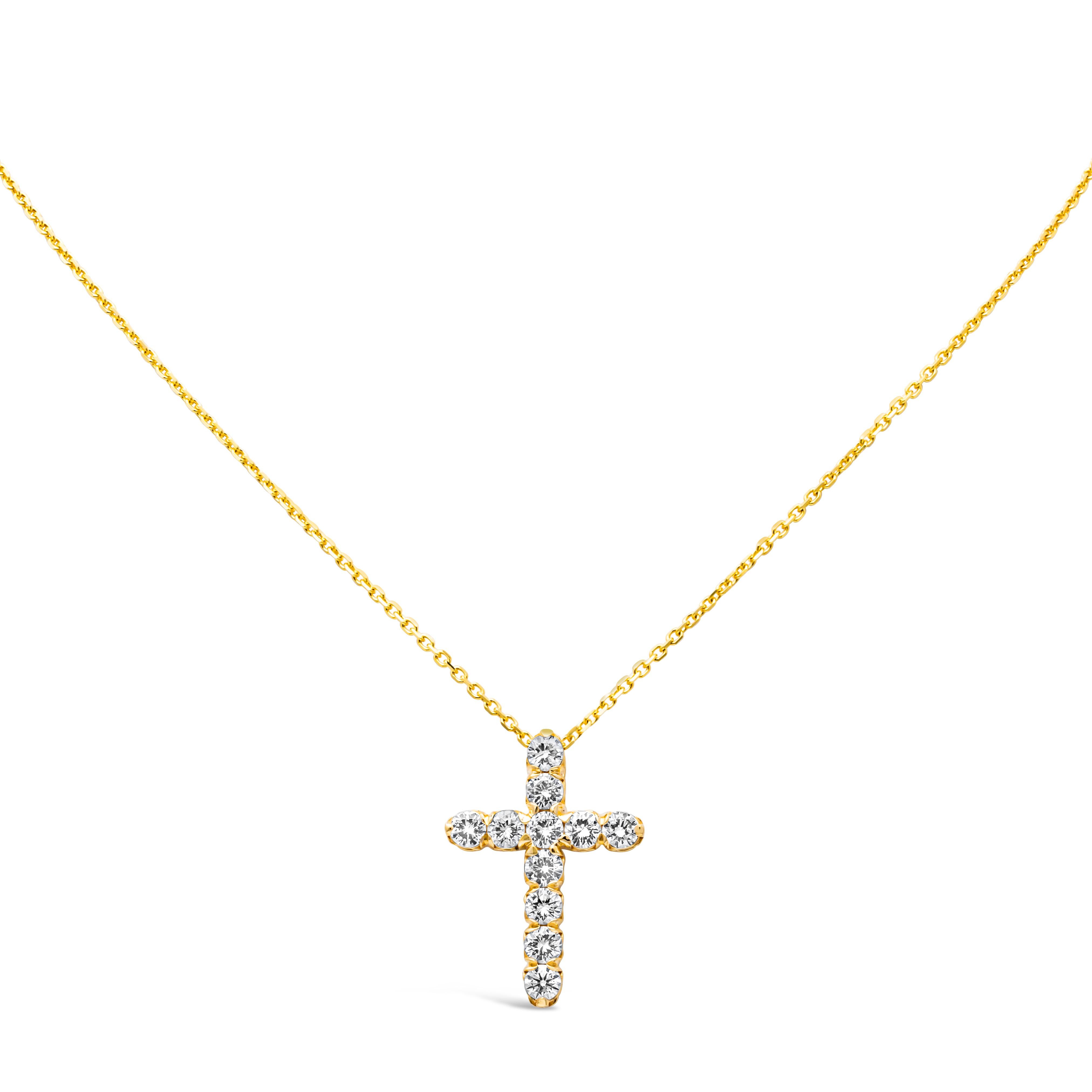 A classy and stunning pendant necklace showcasing 11 brilliant round cut diamond weighing 1.50 carats total, G color and VS in clarity, set in a religious cross design shared prong setting. Finely made in 18K Yellow Gold, Suspended on an 18 inch