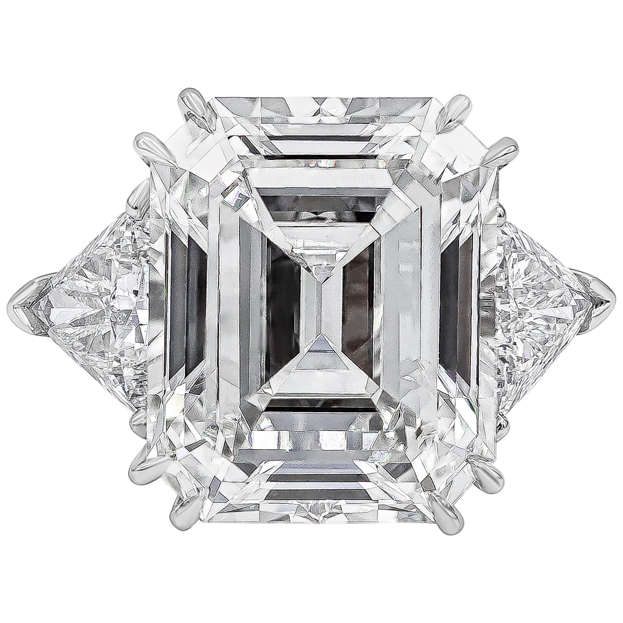 Finely made and well crafted three stone engagement ring featuring a 15.34 carats emerald cut diamond certified by GIA as H color and VS1 in clarity. Flanked by trillion cut diamonds on each side. Accent diamonds weigh 2.15 carats total, H color and