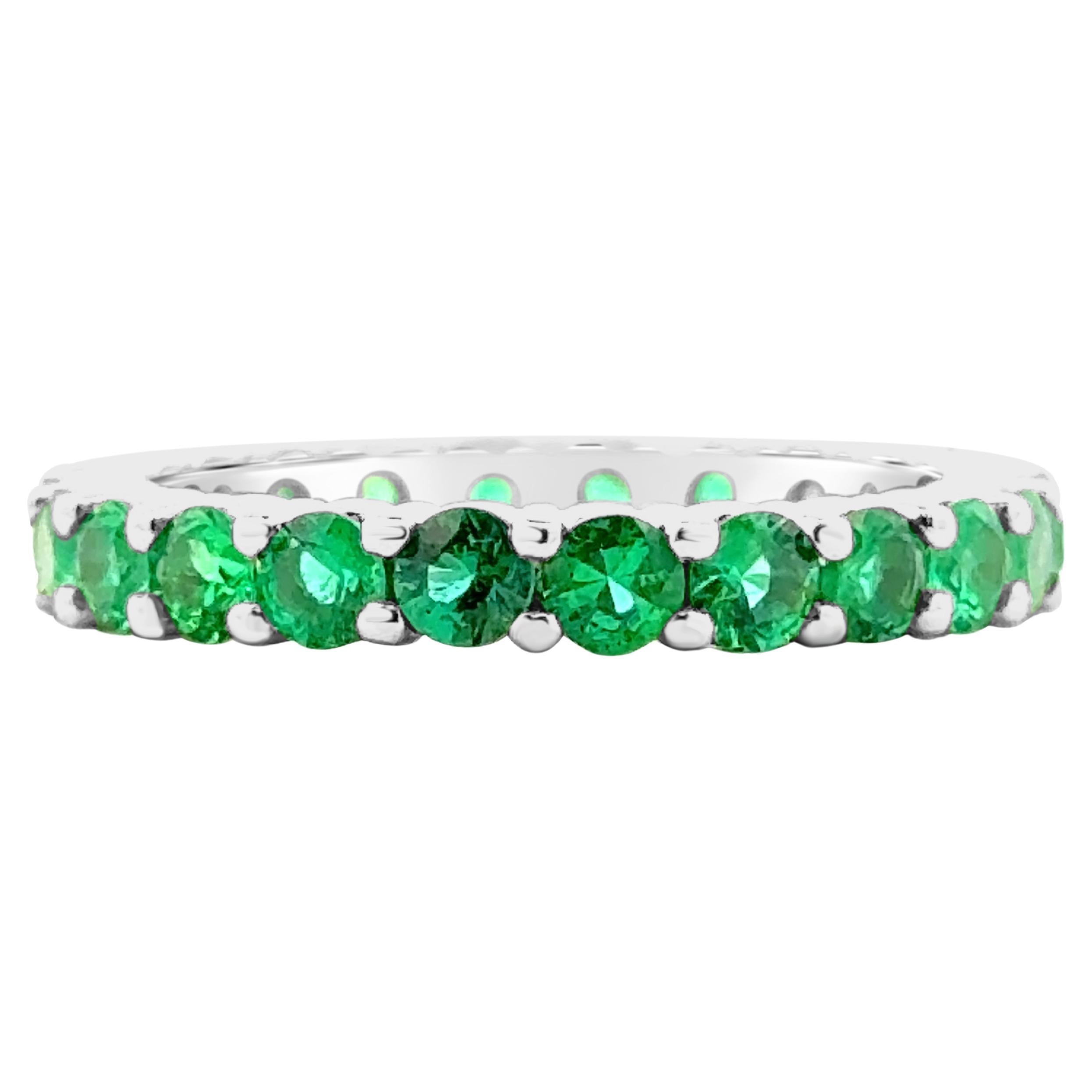 A chic wedding band, featuring an eternity design of 22 round cut green emeralds weighing 1.56 carats total. Made with a platinum mounting, 2.8 mm in width. Size 6 US, resizable upon request.

Roman Malakov is a custom house, specializing in