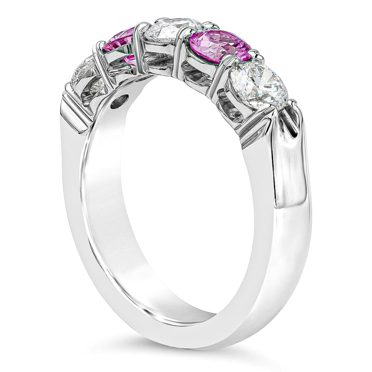 A fashionable five-stone wedding band ring style showcasing vibrant pink sapphires weighing 0.72 carats, that alternates with round brilliant diamonds weighing 0.90 carats. Mounted in a shared-prong setting, Made with Platinum. Size 6.5 US 

Roman