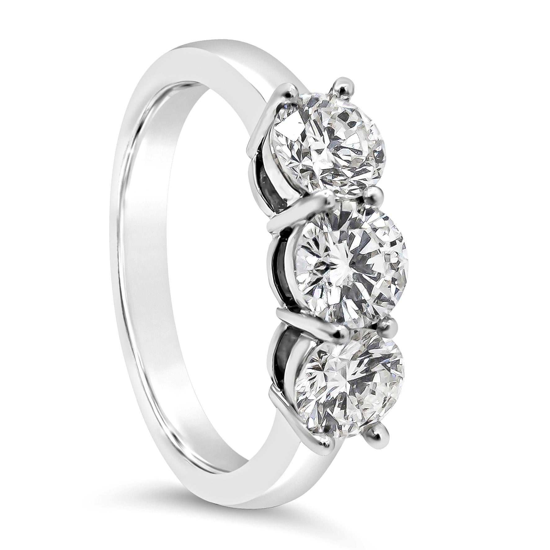 A classy and chic wedding band showcasing three round brilliant diamonds set in a timeless shared prong setting in a polished platinum mounting weighing 1.63 carats total, J color, VS in clarity. Size 7.25 US resizable upon request.

Style available