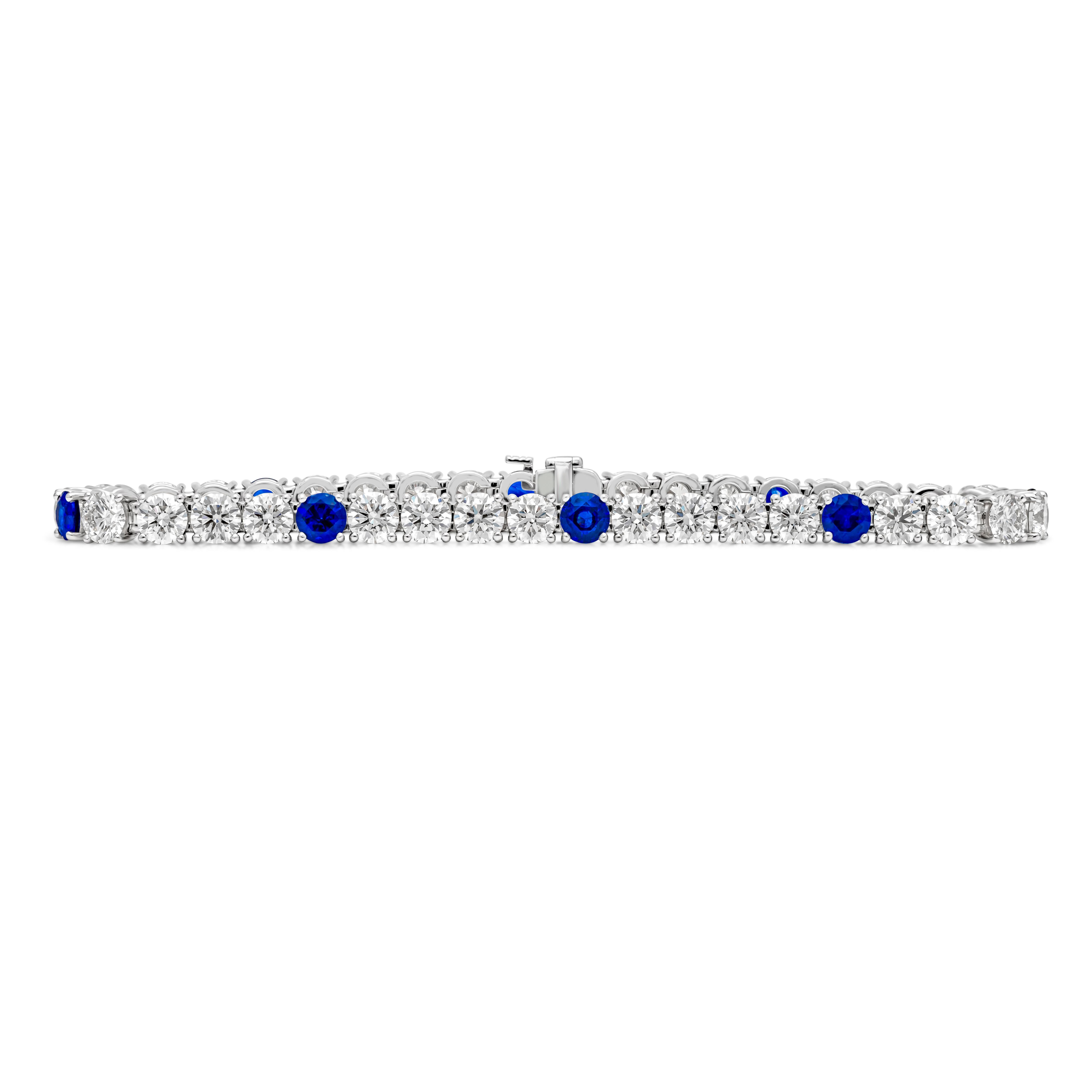An exquisite and classy tennis bracelet, showcasing 32 round brilliant cut diamonds weighing 13.00 carats total with G color and VS clarity, set on a classic four prong basket setting finely made in 18K white gold. Elegantly spaced by 8 color-rich