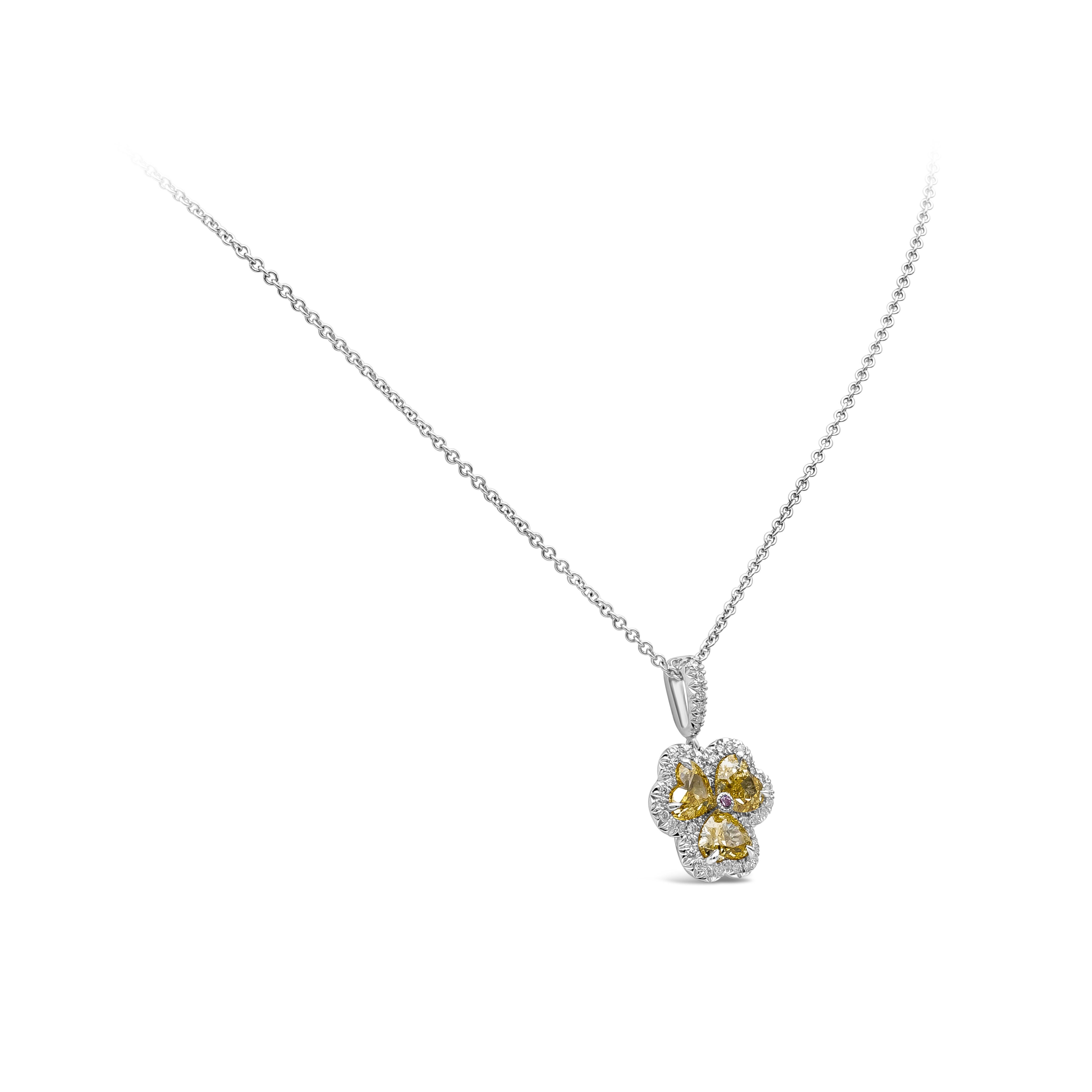 A simple yet beautiful pendant necklace showcasing 3 fancy yellow color clover shape cut diamonds set in a flower designed setting. Each heart shape cut diamonds is accented by a single row of round brilliant diamonds. Fancy yellow color heart shape