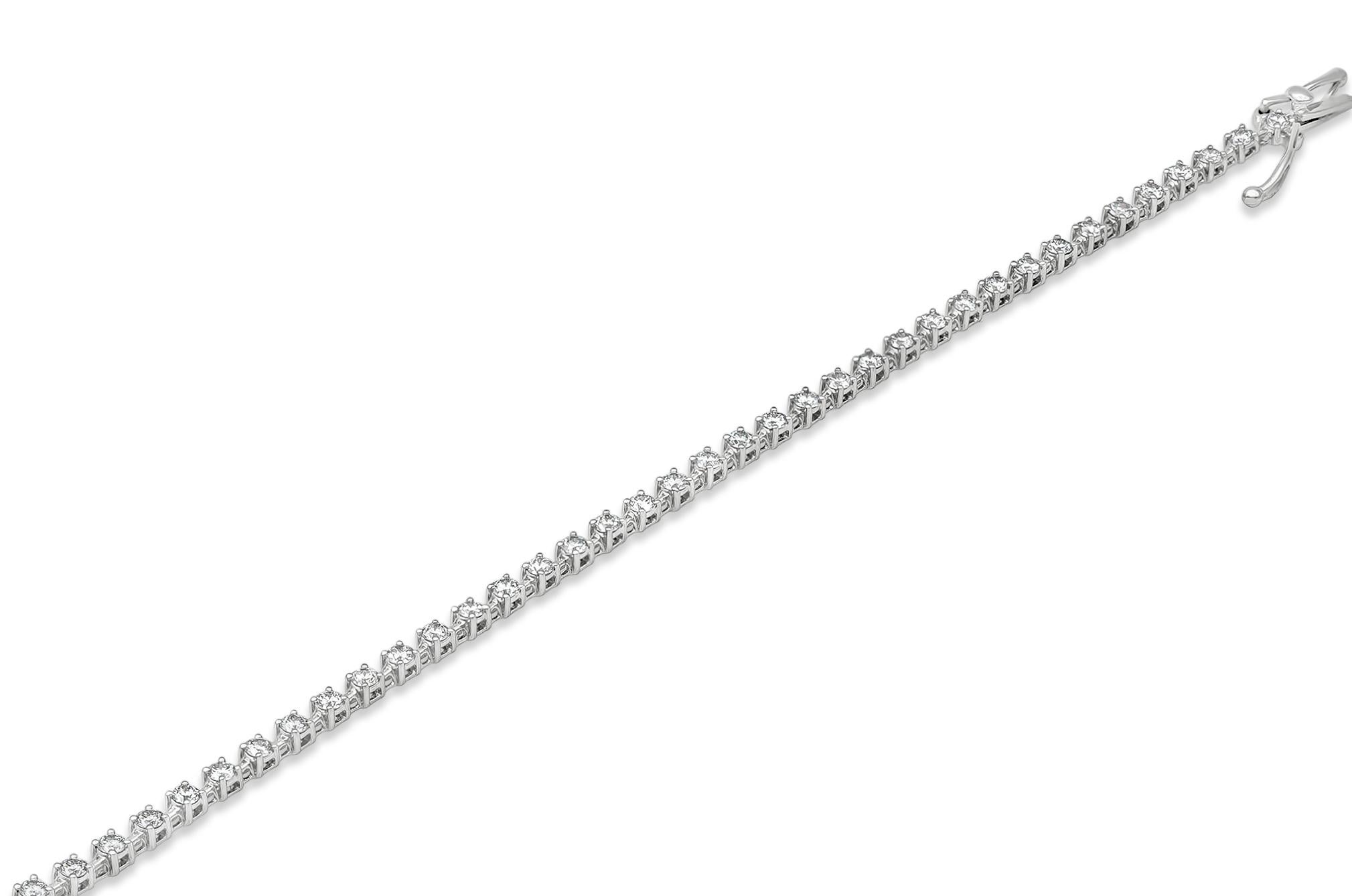 Classic tennis bracelet showcasing a row of round brilliant diamonds weighing 1.67 carats total, set in an 18k white gold mounting. Diamonds are approximately F color, VS clarity. 

Style available in different price ranges. Prices are based on your