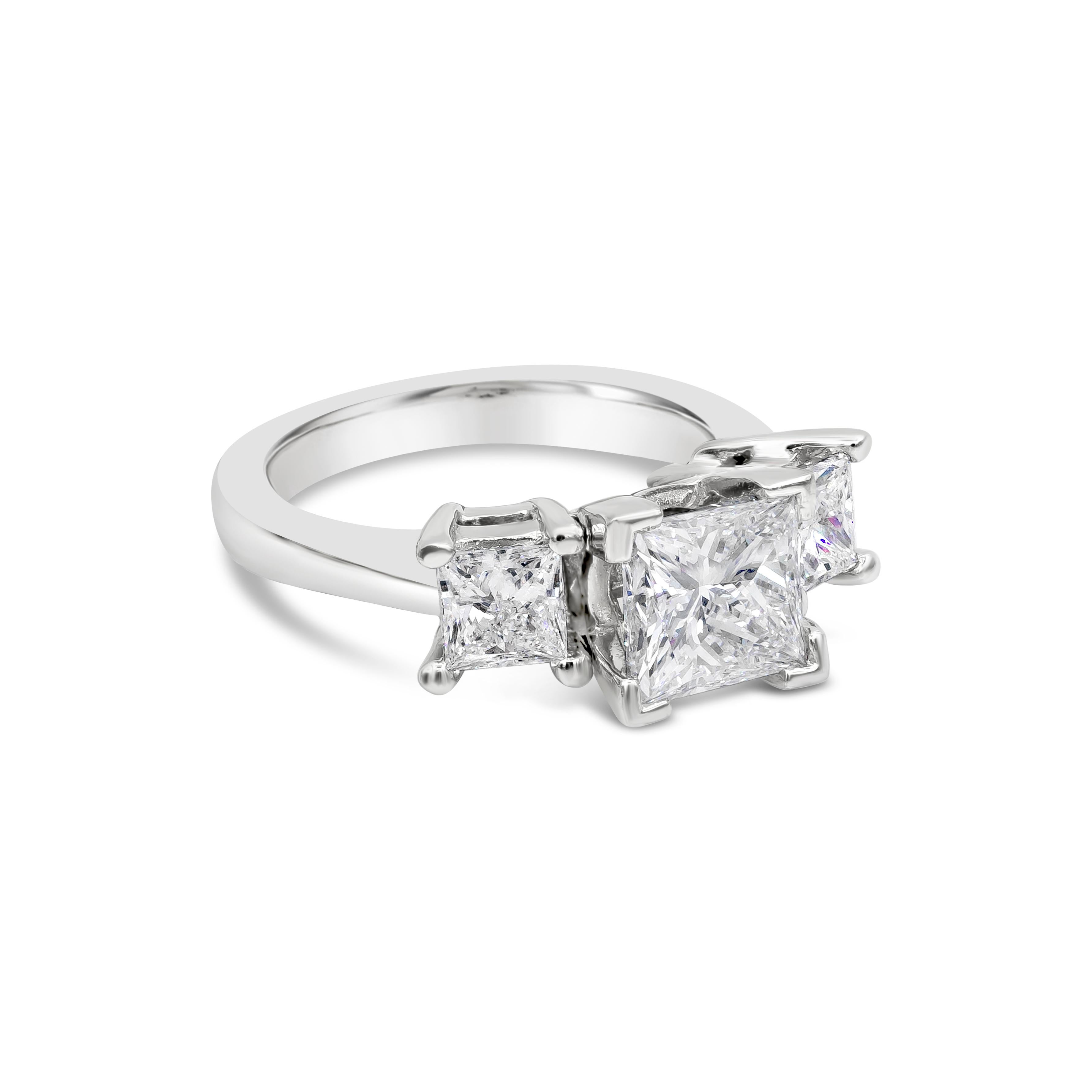 A timeless and popular engagement ring style showcasing a 1.70 carat princess cut diamond flanked by two smaller princess cut diamonds weighing 0.80 carats total. GIA certified the center diamond as F color, SI2 clarity. Set in an tapering platinum