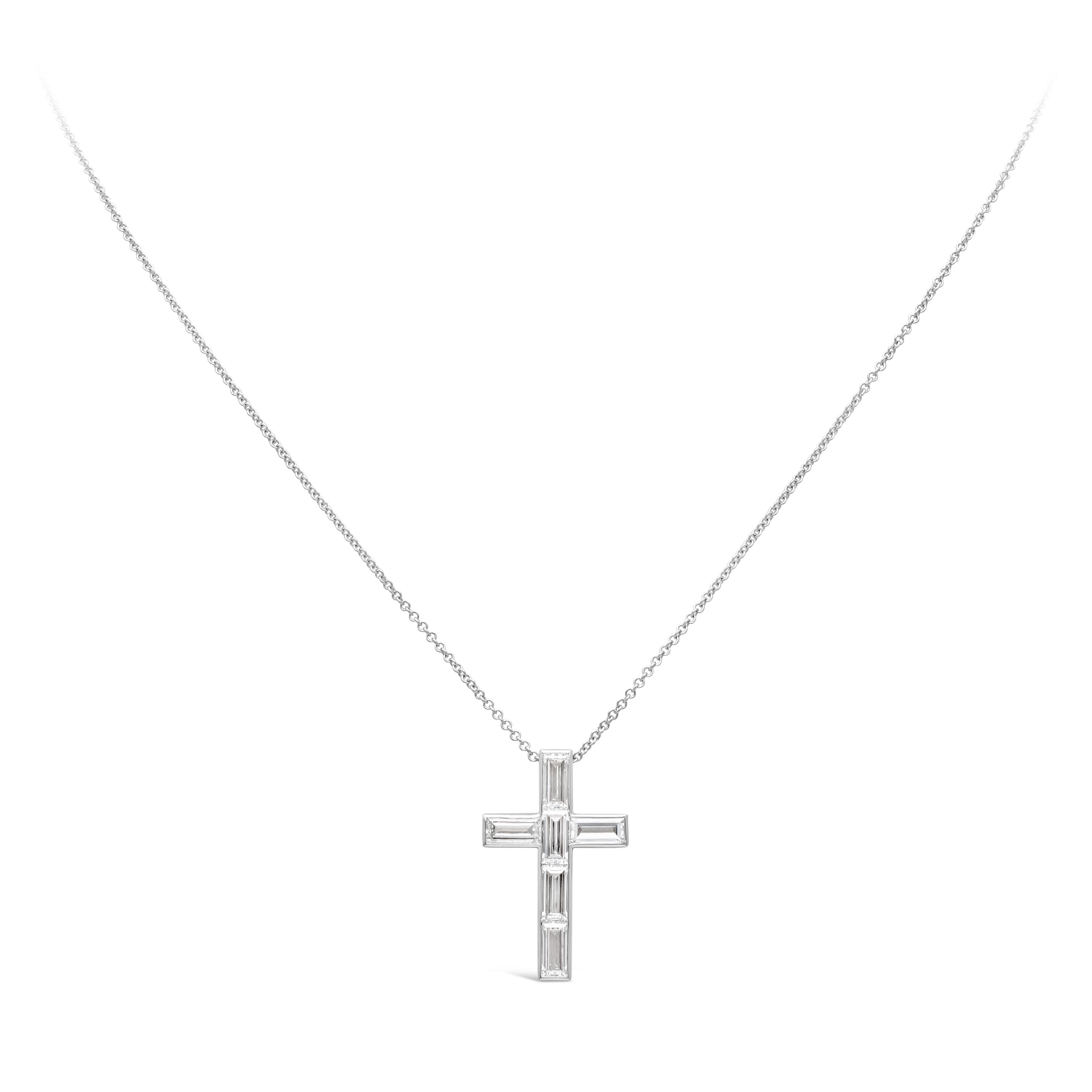 Showcasing a classic and simple religious cross pendant necklace set with baguette cut diamonds in a bezel set design weighing 1.76 carats total, G color and VS+ in clarity. Suspended on an adjustable 18inches white gold chain. Finely made in 18k