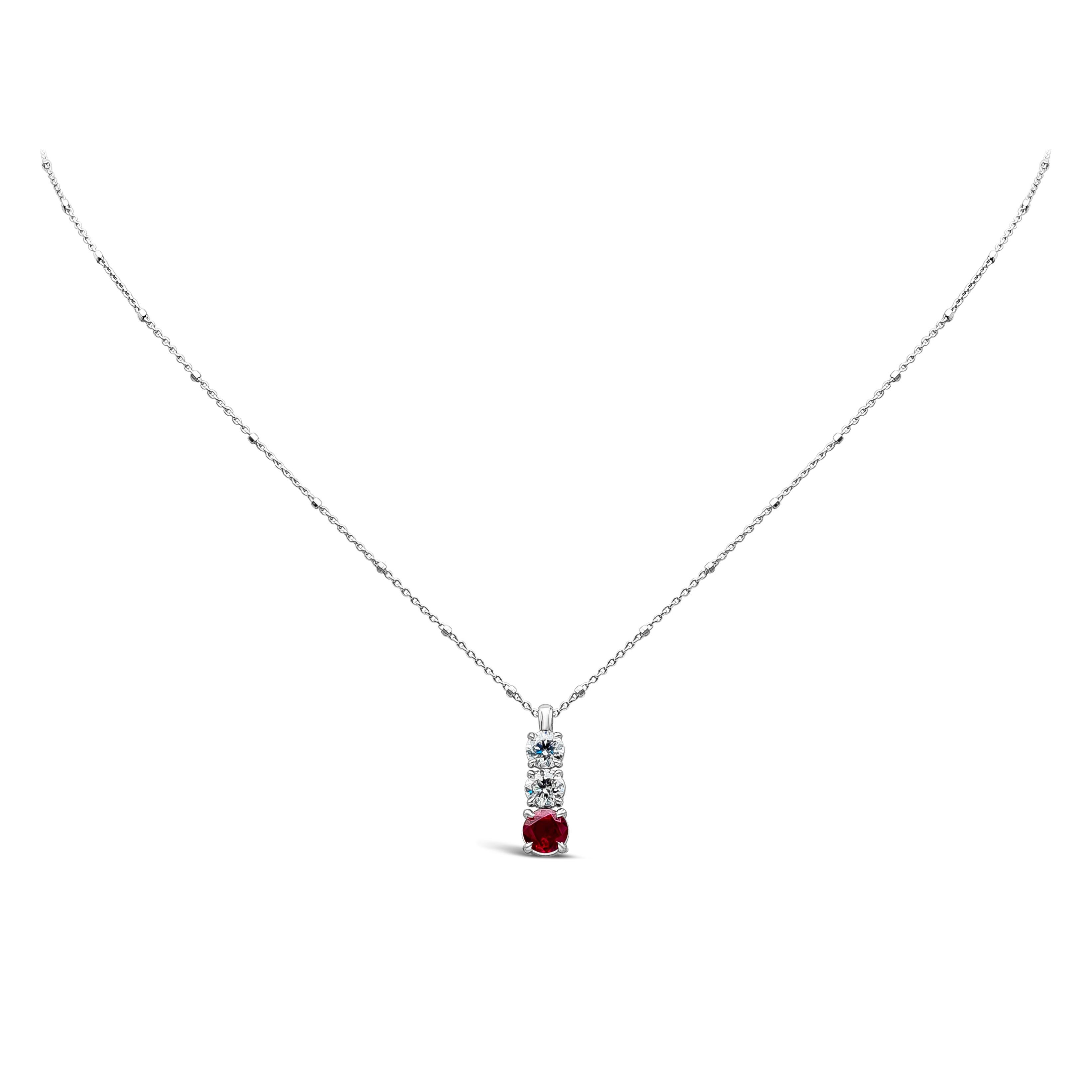 A simple and very stylish piece of jewelry features a three-stone pendant necklace showcasing a burma ruby weighing 0.89 carat total, and round white diamonds weighing 0.87 carats total, F Color and SI in Clarity. Set in a classic 4 prong setting,