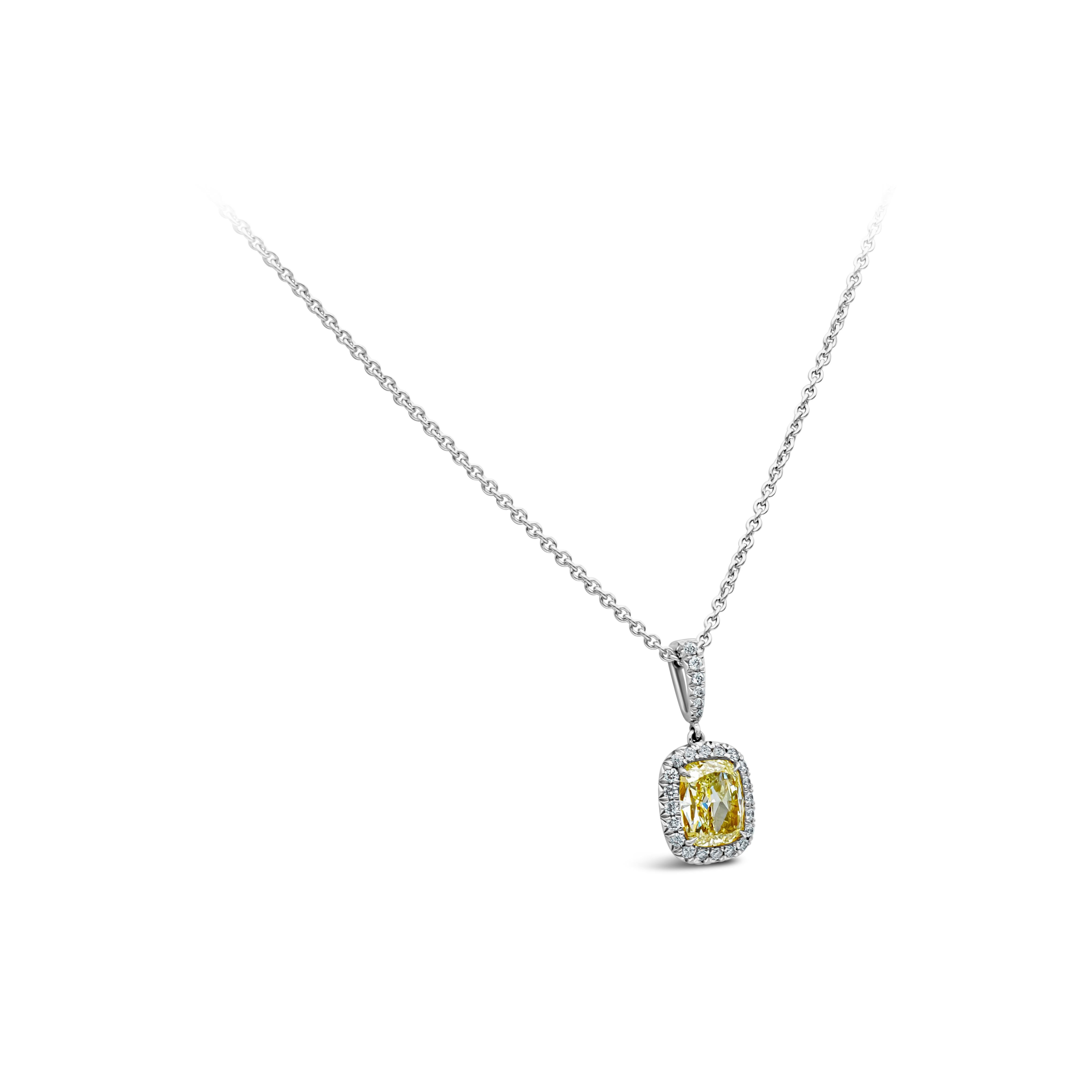 This classy and simple pendant necklace showcasing a color-rich GIA certified 1.55 carats cushion cut diamond, Y-Z color and SI1 clarity. Set in four prong Platinum setting. Surrounded by 26 brilliant round cut diamonds in a halo design, weighing in