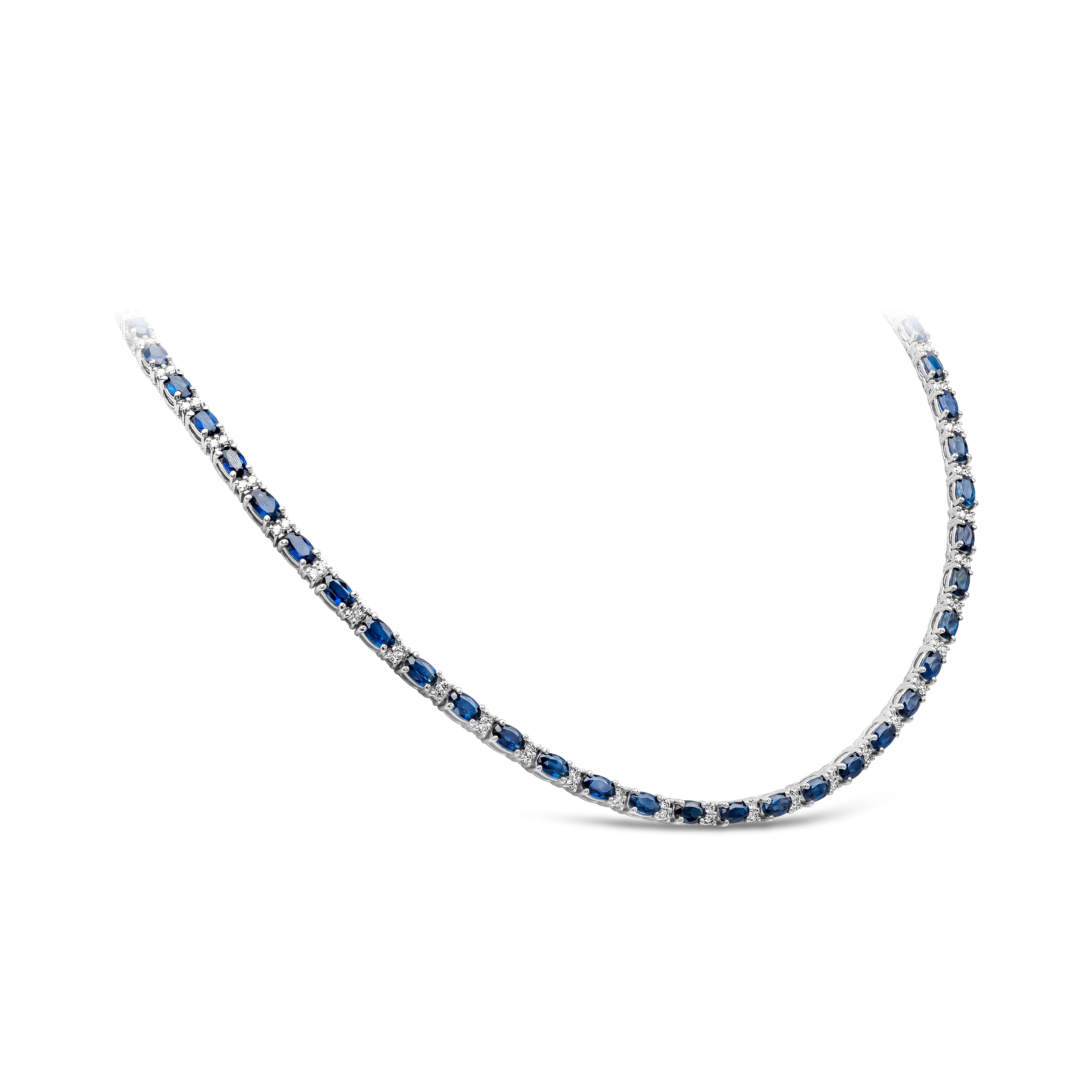 An incredibly color-rich tennis necklace showcasing 17.80 carats total of oval cut blue sapphire, each elegantly spaced by two round brilliant diamonds weighing 1.61 carats total. Made in 14k white gold. Approximately 16 inches in length & can be