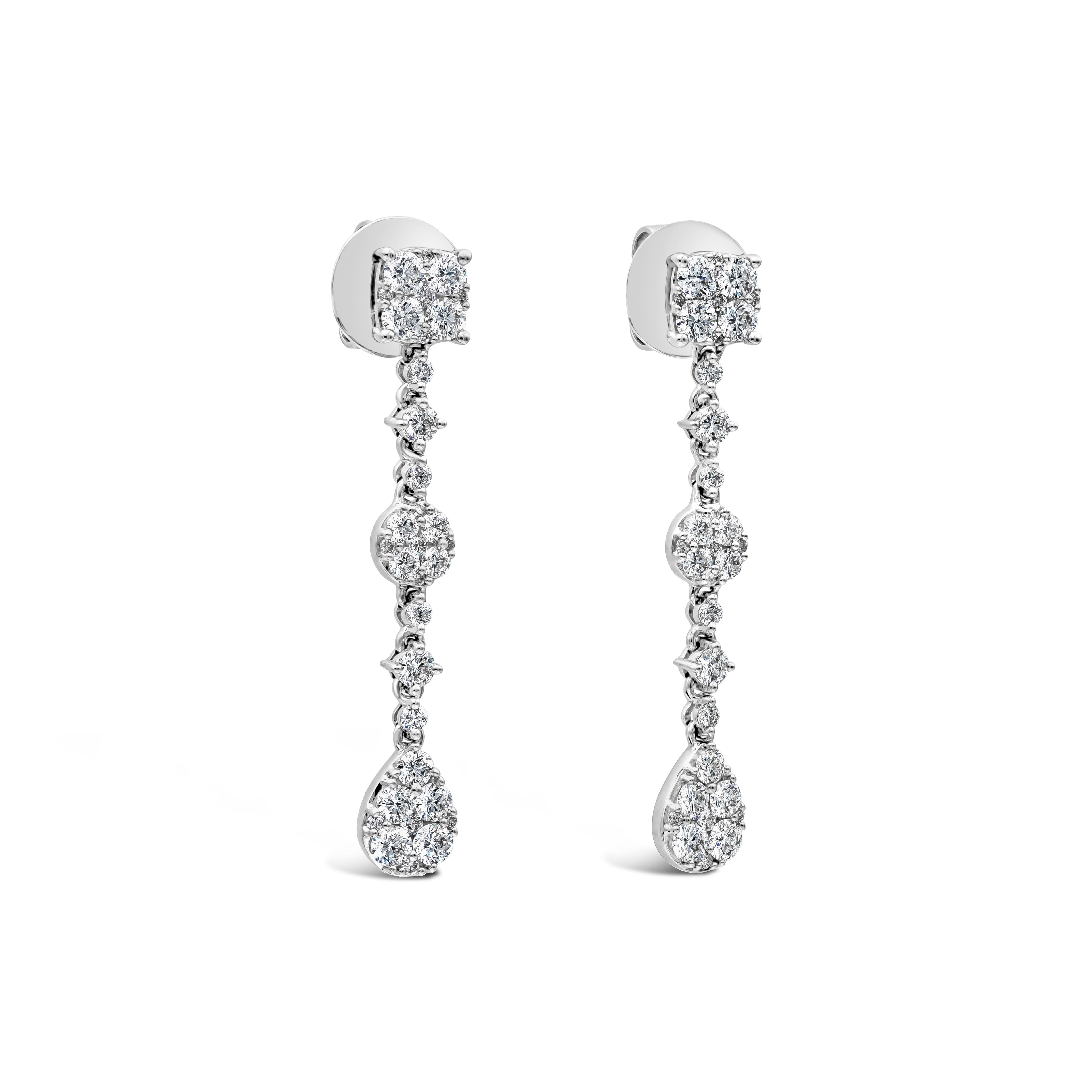 This classy pair of drop earrings showcasing a clusters of 66 brilliant round diamonds set in a cushion, round, and pear shape mountings, arranged in an elegant drop spaced by round diamonds. The weight of the diamonds is 1.78 carats in total. Made