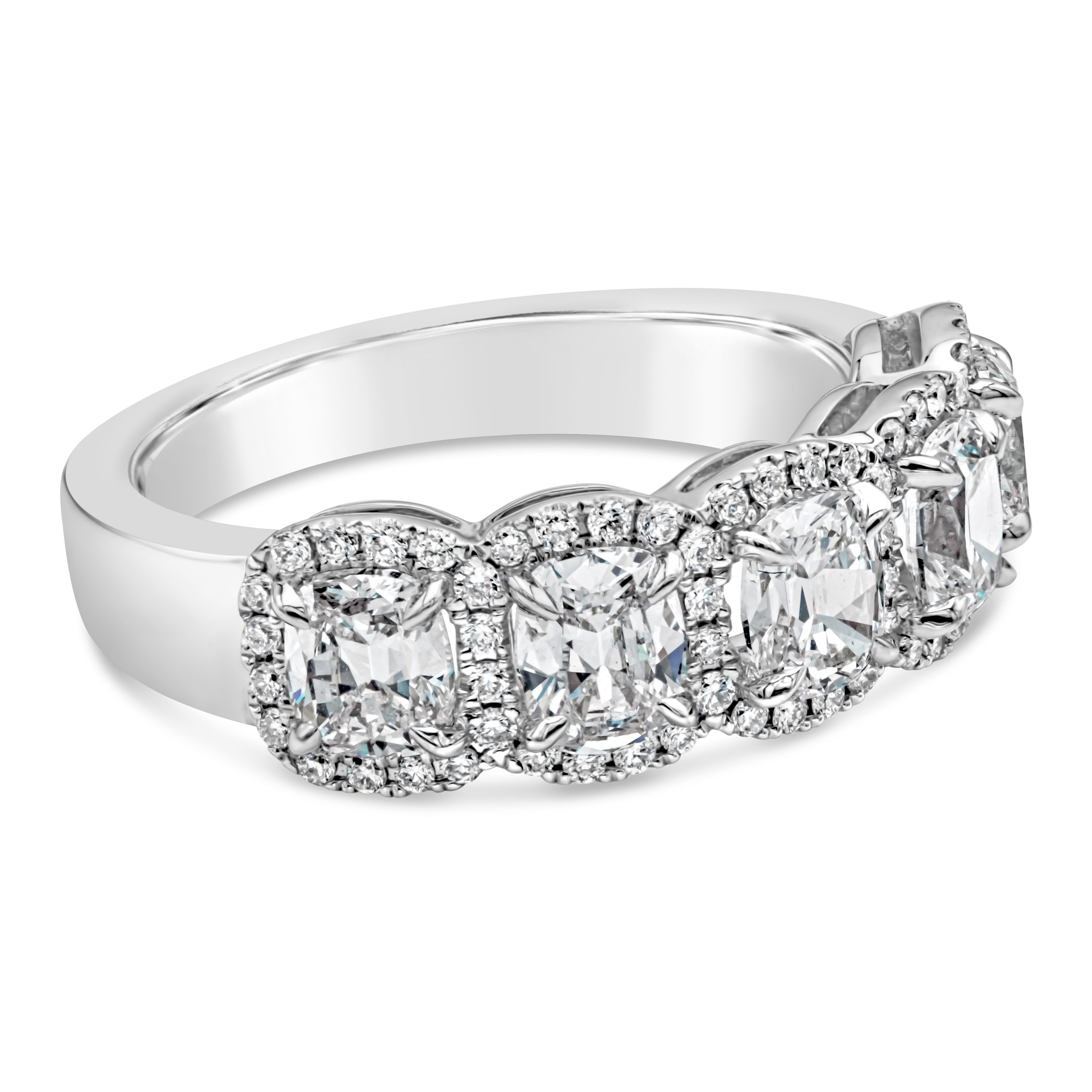 A classic and brilliant five-stone wedding band showcasing five cushion cut diamonds weighing 1.78 carats total, E Color and VS in Clarity. Each cushion cut diamonds are accented by brilliant round diamonds weighing 0.29 carats total. Made with 18K