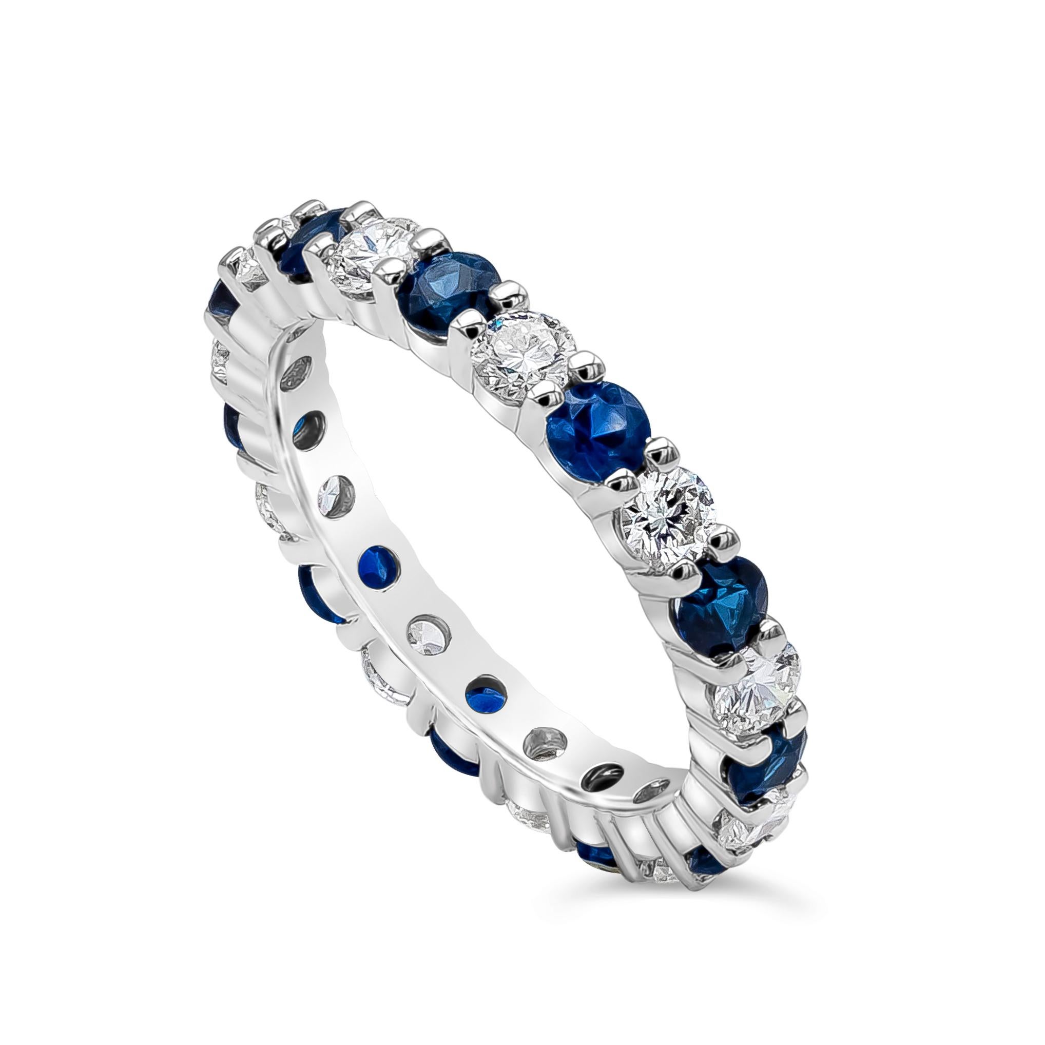 This sophisticated eternity wedding band features gleaming brilliant round diamonds alternating with blue sapphire. An infinite row of round elegant alternating sapphire weighs 0.94 carats and the brilliant round diamonds weighs 0.85 carats, H in