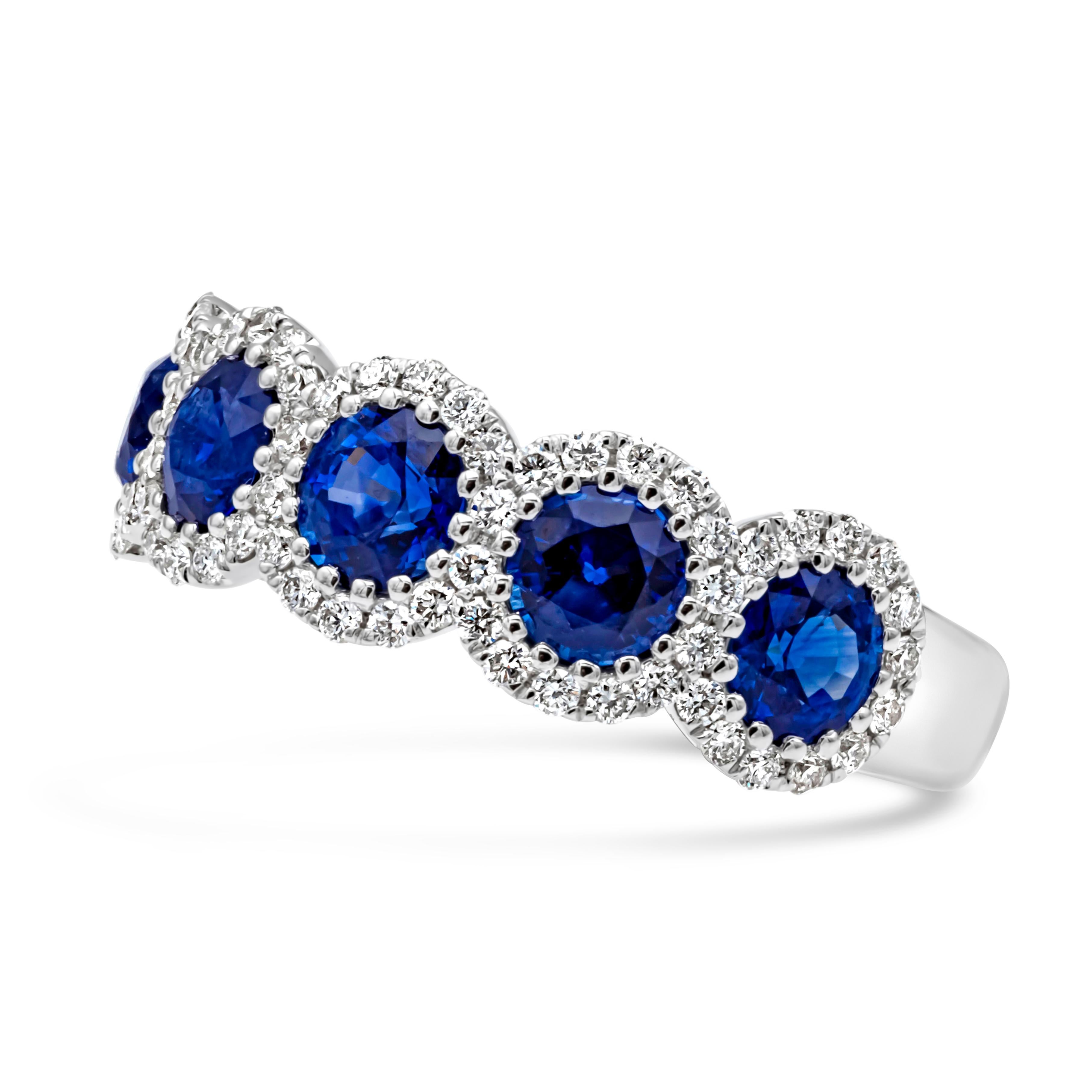 A classic and brilliant wedding band featuring five brilliant round cut blue sapphires weighing 1.88 carats total, set in a timeless fourteen prong basket setting and each round cut blue sapphires are surrounded by brilliant round diamonds weighing