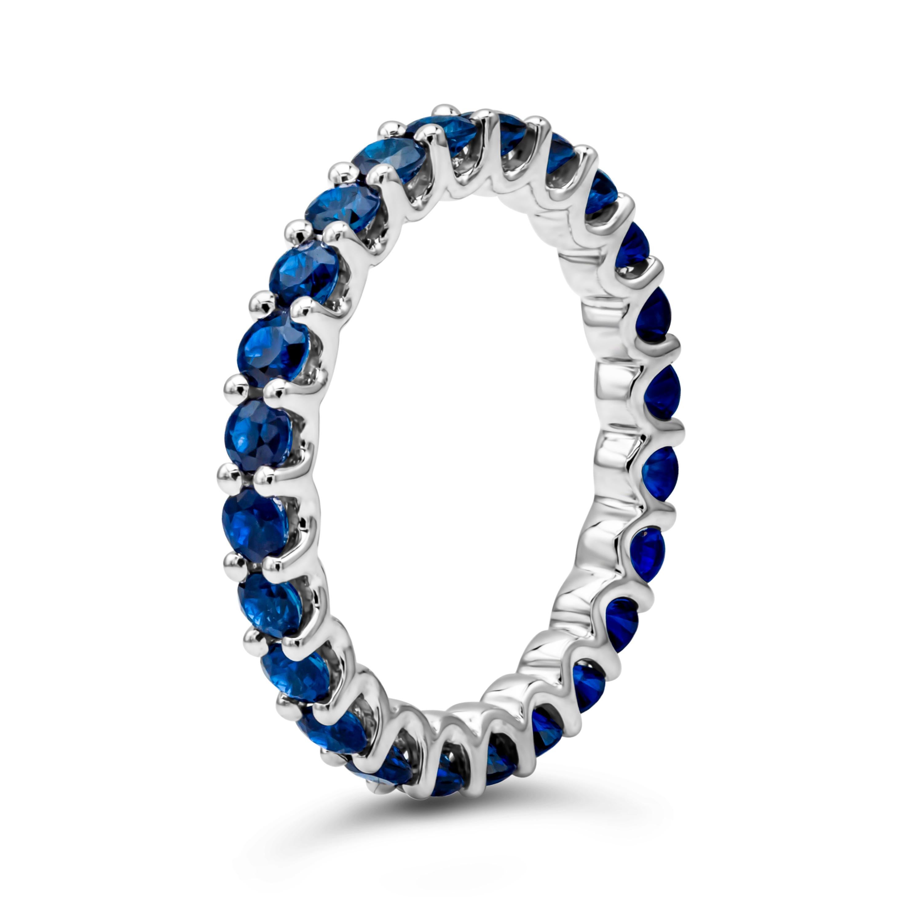 An appealing eternity wedding band style showcasing a color-rich brilliant round cut blue sapphires weighing 1.95 carats total, set in a classic shared prong setting. Finely made in 18k white gold. Size 6.5 US resizable upon request.

Style