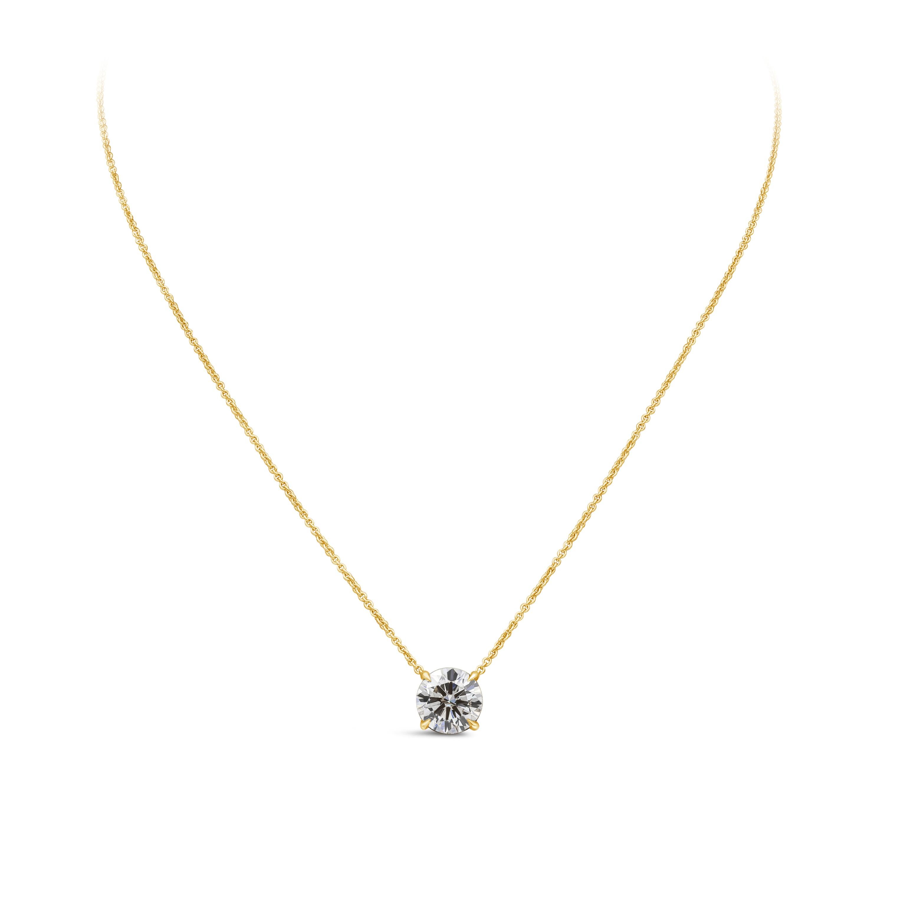 A classic solitaire pendant necklace, showcasing a single round brilliant cut diamond weighing 2.01 carats with K color and I1 clarity. Set on a traditional four-prong setting and made with 14K yellow gold. Suspended on an 18 inches yellow gold