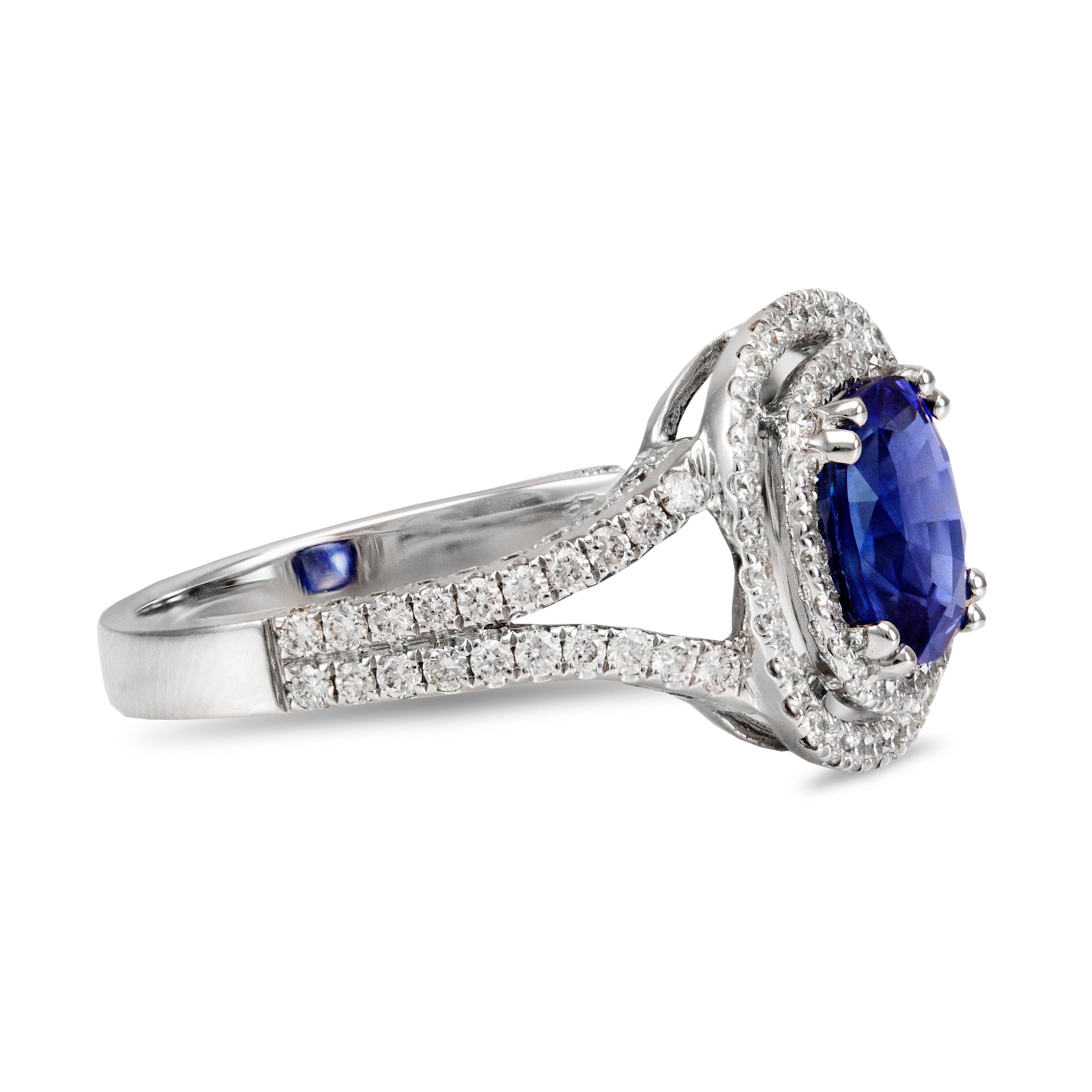 This elegant and stunning engagement ring features a cushion-cut natural sapphire center stone, deep blue color, weighing 2.06 carats total. Accented by 2 rows of brilliant round diamonds weighing 0.78 carats total. Made with 18K White Gold. Size