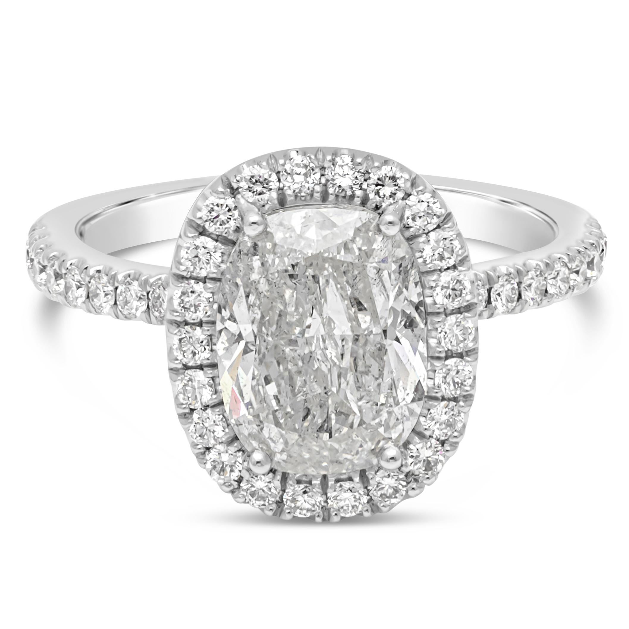 A classic engagement ring style showcasing a 2.07 carat rectangular cushion cut diamond, F color, I1 in clarity EGL Certified. Center stone accented by a row of round brilliant diamonds. Set in a haft eternity pave made in 18K white gold. Accent