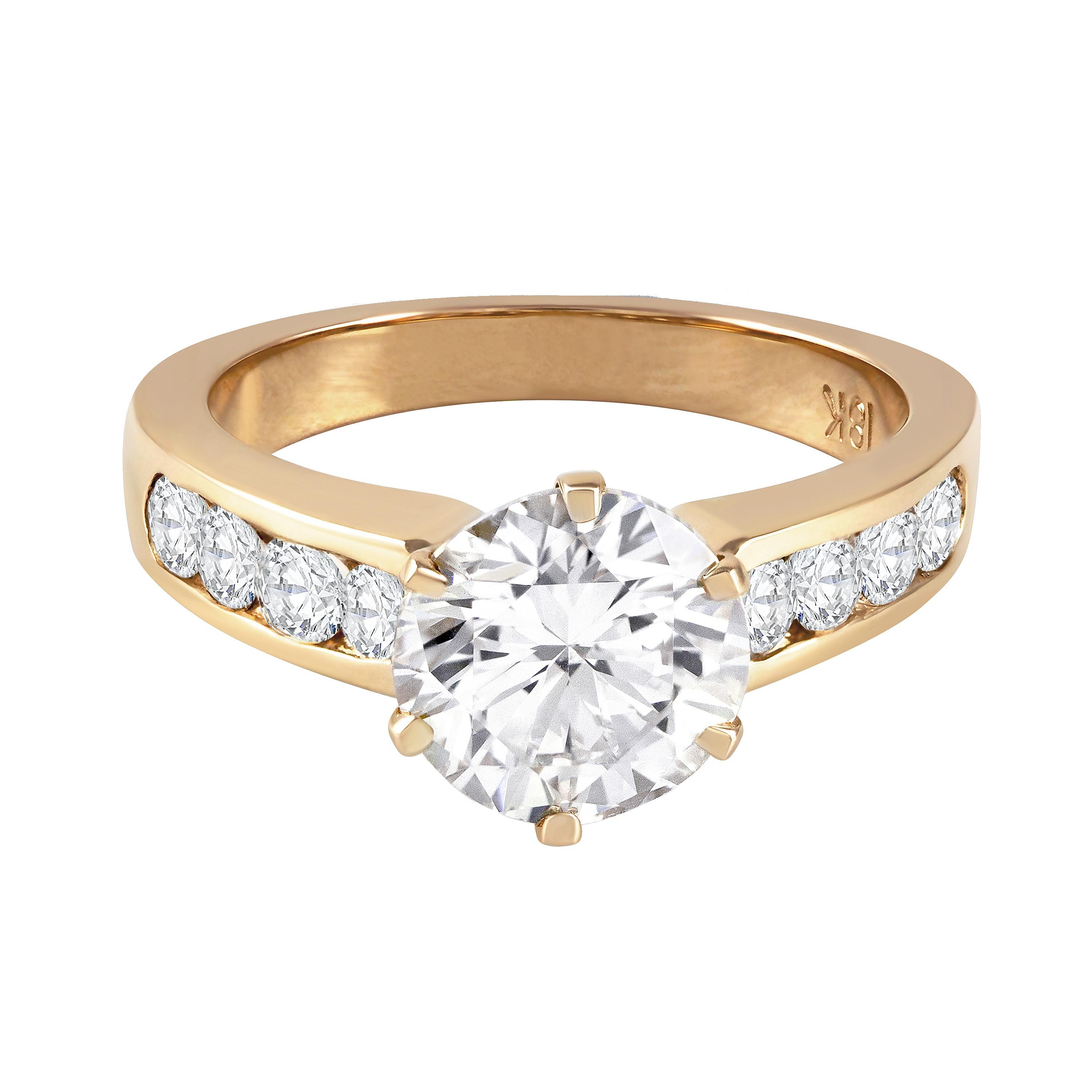 A classic engagement ring, featuring a 2.15 carats round brilliant cut diamond, set on a six prong setting. Accented by channel-set round brilliant cut diamonds weighing 0.50 carat total with a half-eternity design. Finely made with an 18K rose gold