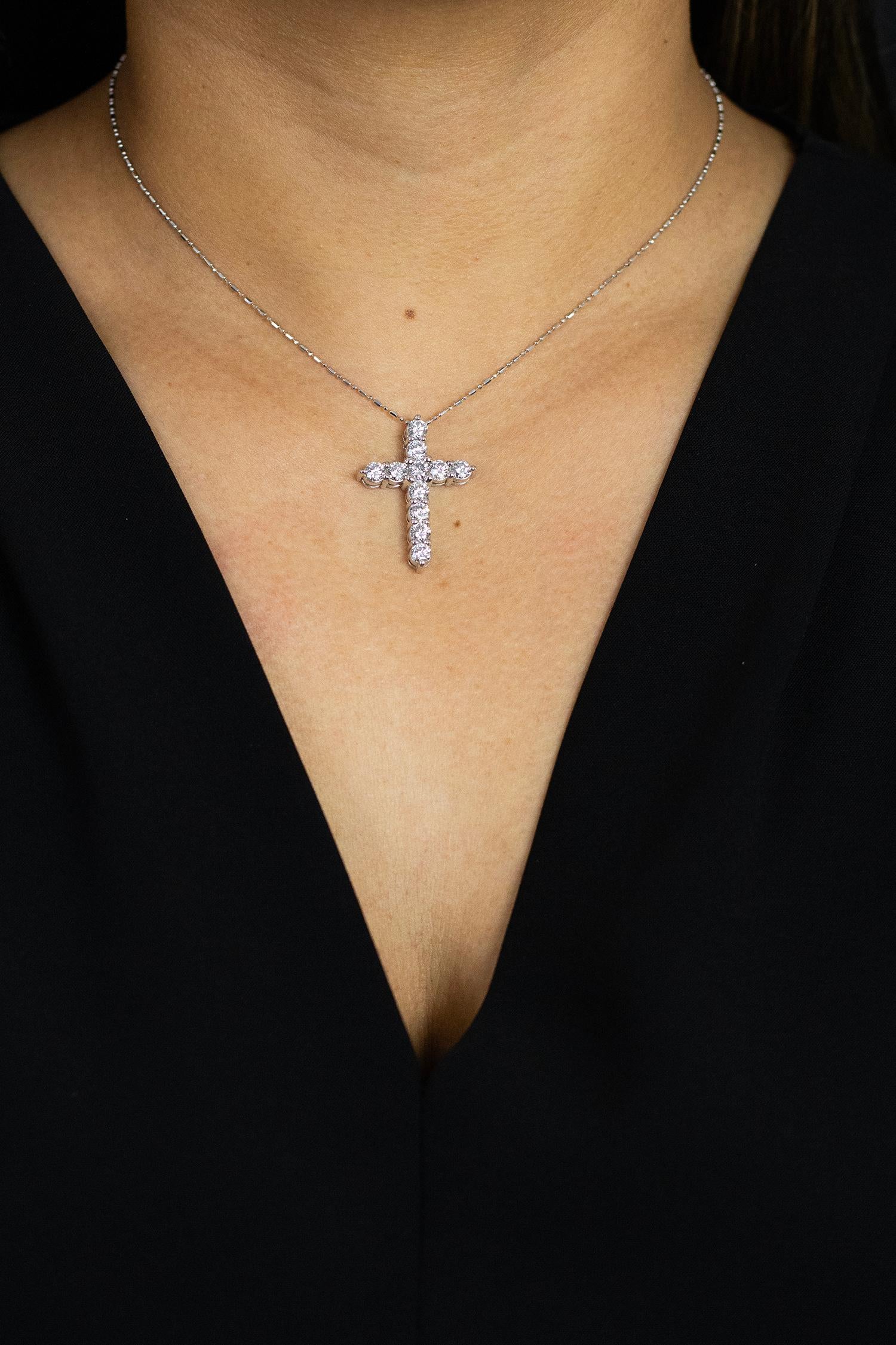 A classic cross design set with 2.24 carats total of round brilliant diamonds. Diamonds  quality are G color, VS clarity; and suspended in a 14k white gold mounting and chain. 16 inch chain length (adjustable upon request).

Roman Malakov is a