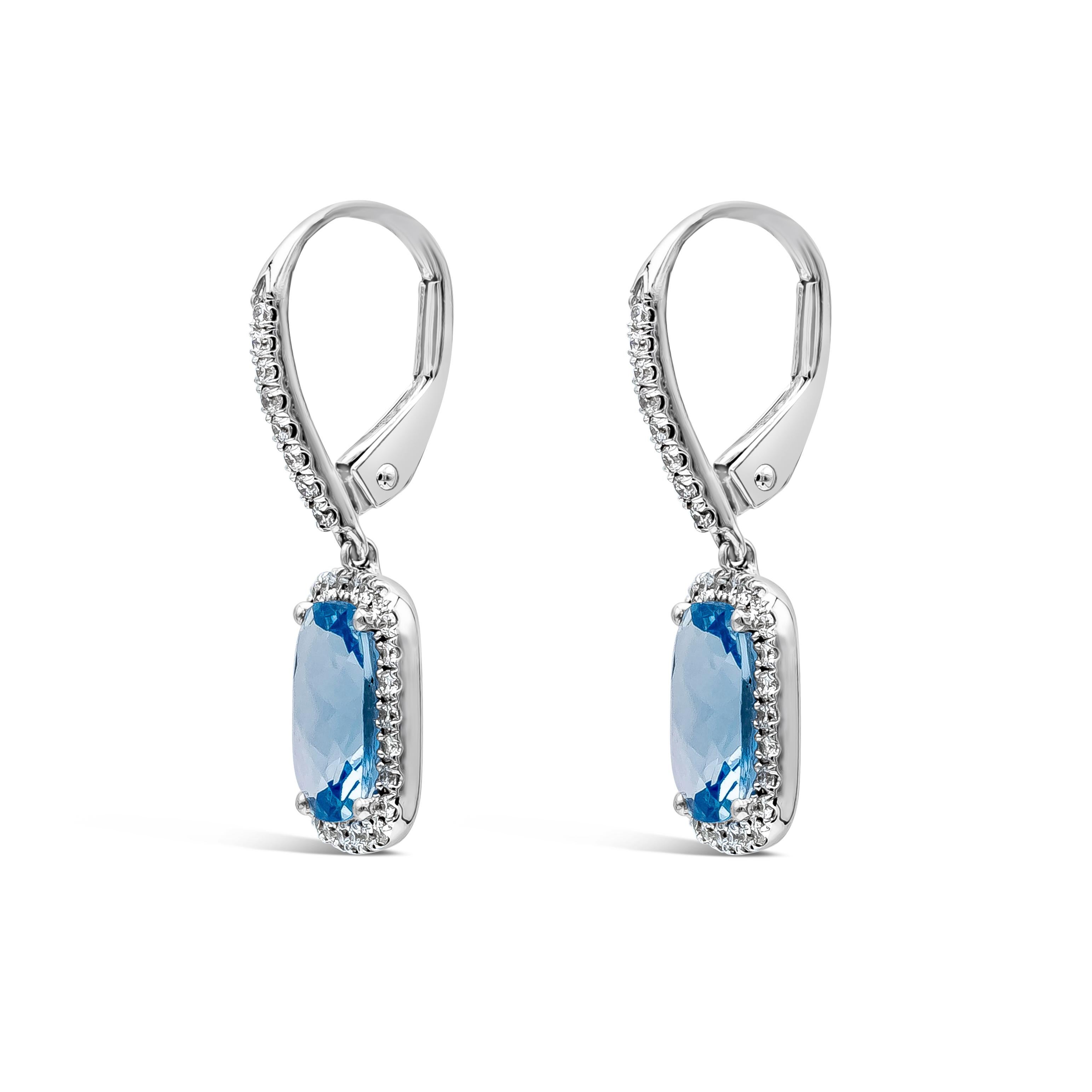 This gorgeous pair of drop earrings is showcasing a cushion cut aquamarines weighing 2.25 carats total, surrounded by a row of round brilliant diamonds weighing 0.33 carats total, F Color and VS in Clarity. Made with 18K White Gold.

Roman Malakov