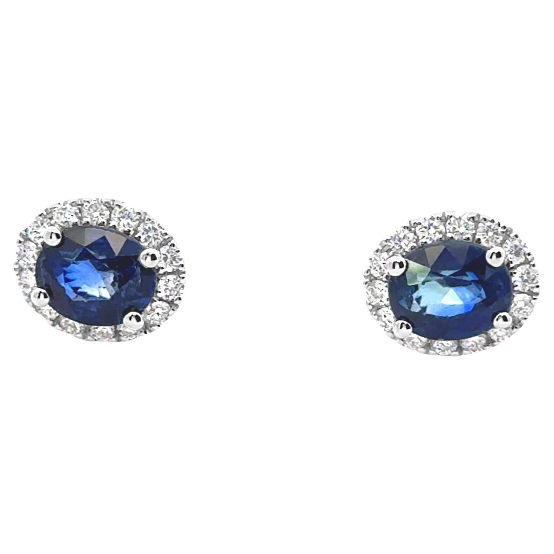 Une belle paire de boucles d'oreilles, avec des saphirs de taille ovale pesant 2,25 carats au total, montés sur une monture à quatre griffes. Accentué par un halo de diamants de taille ronde pesant 0,32 carat au total, serti sur une belle monture