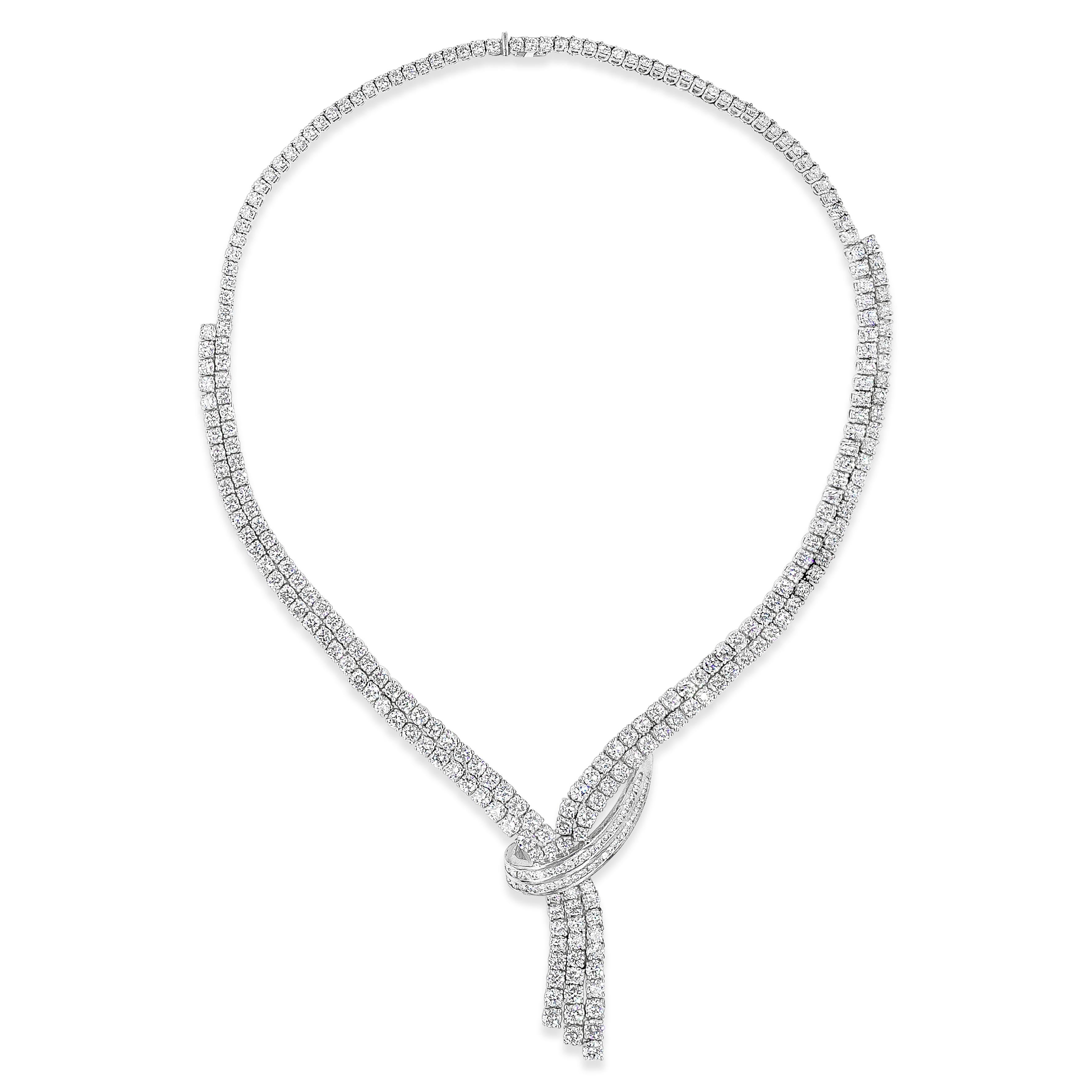 A beautiful and important drop necklace showcasing two rows of round brilliant diamonds that elegantly drop and divide into three rows of diamonds. Diamonds weigh 24.28 carats total. Finely made in 18k white gold and 20.12 inches in length. Also has