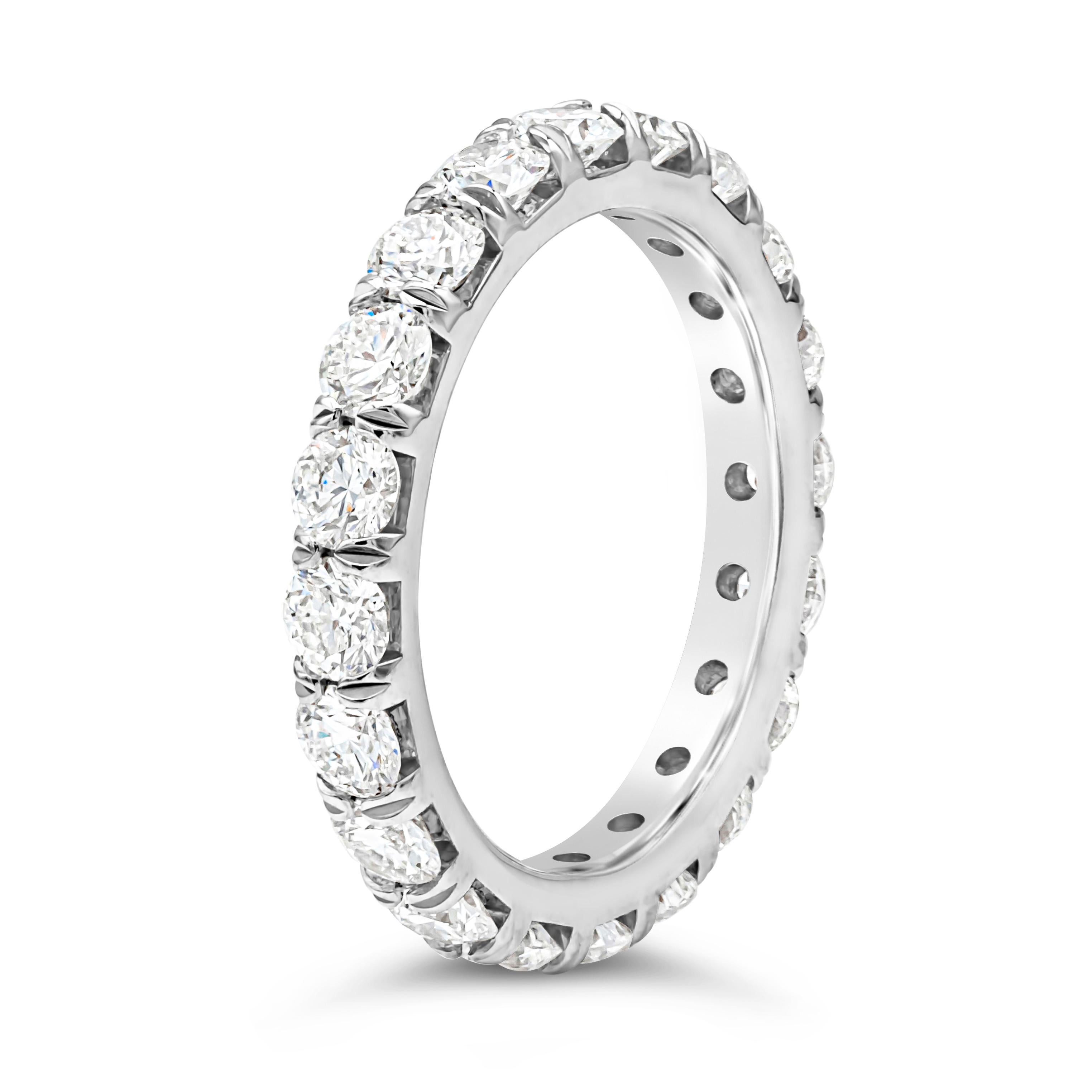 A classy and simple eternity wedding band showcasing a line of 20 brilliant round cut diamonds weighing 2.45 carats total, G color and VS in clarity, set in a four prong basket setting and French pave set. Finely made in platinum. Size 6.5 US