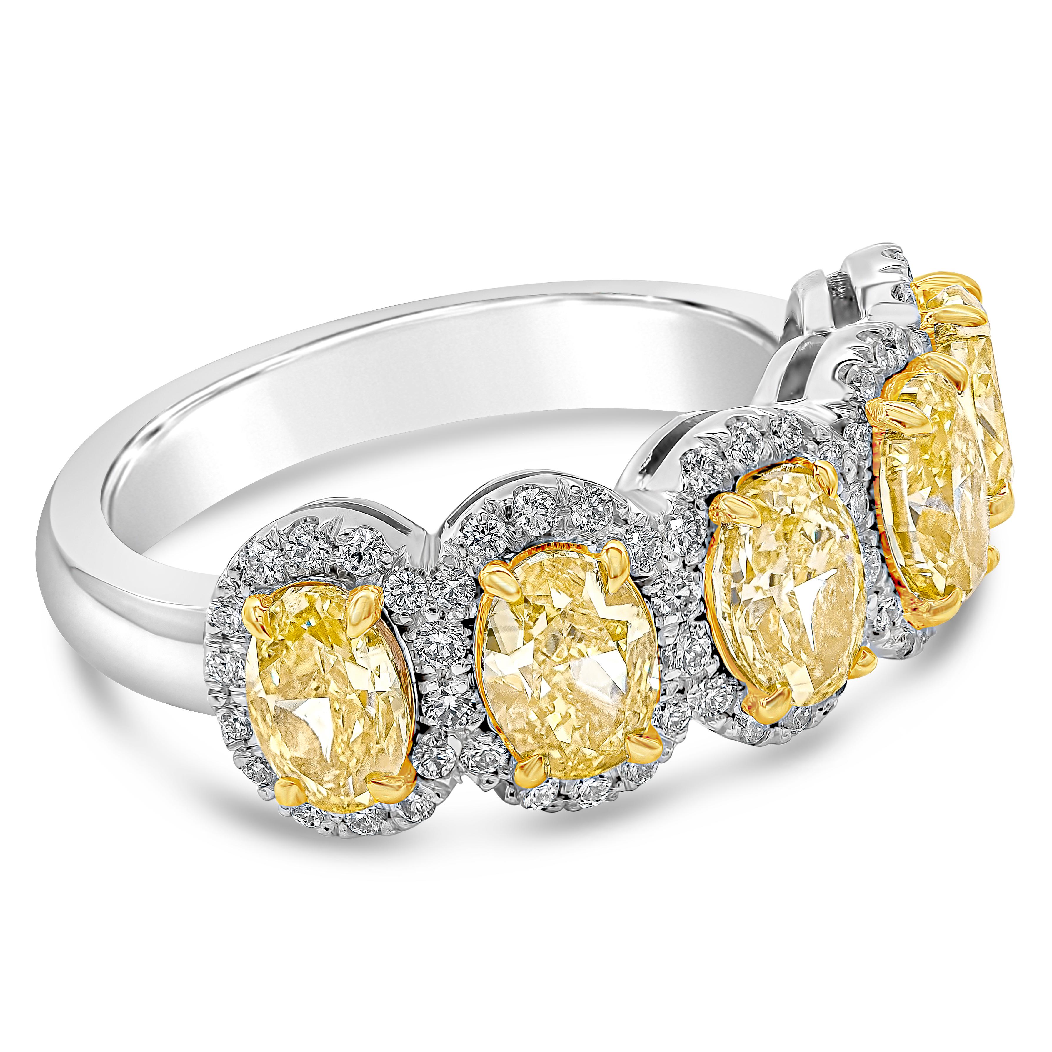 A color-rich ring showcasing vibrant and intense oval cut yellow diamonds, each surrounded by a single row of round brilliant diamonds. Yellow diamonds weigh 2.51 carats total, VS in Clarity. White diamonds weigh 0.25 carats total, F Color and VS in