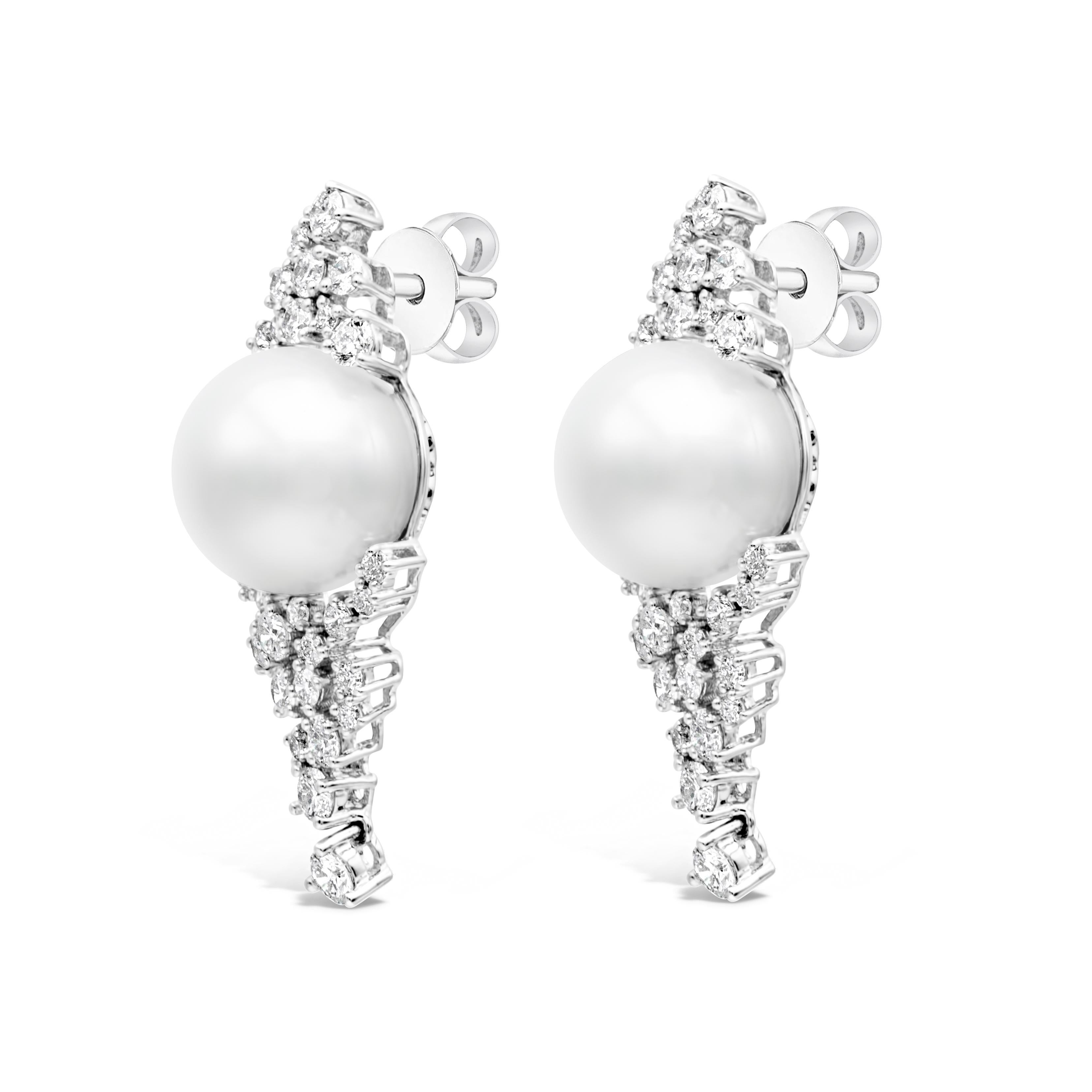 A very elegant earrings showcasing 12-13mm South Sea Pearls attached to a uniquely encrusted design work. It has 56 pieces of round cut diamonds with a total weight of 2.56 carats, mounted in an 18K White Gold. 

Roman Malakov is a custom house,