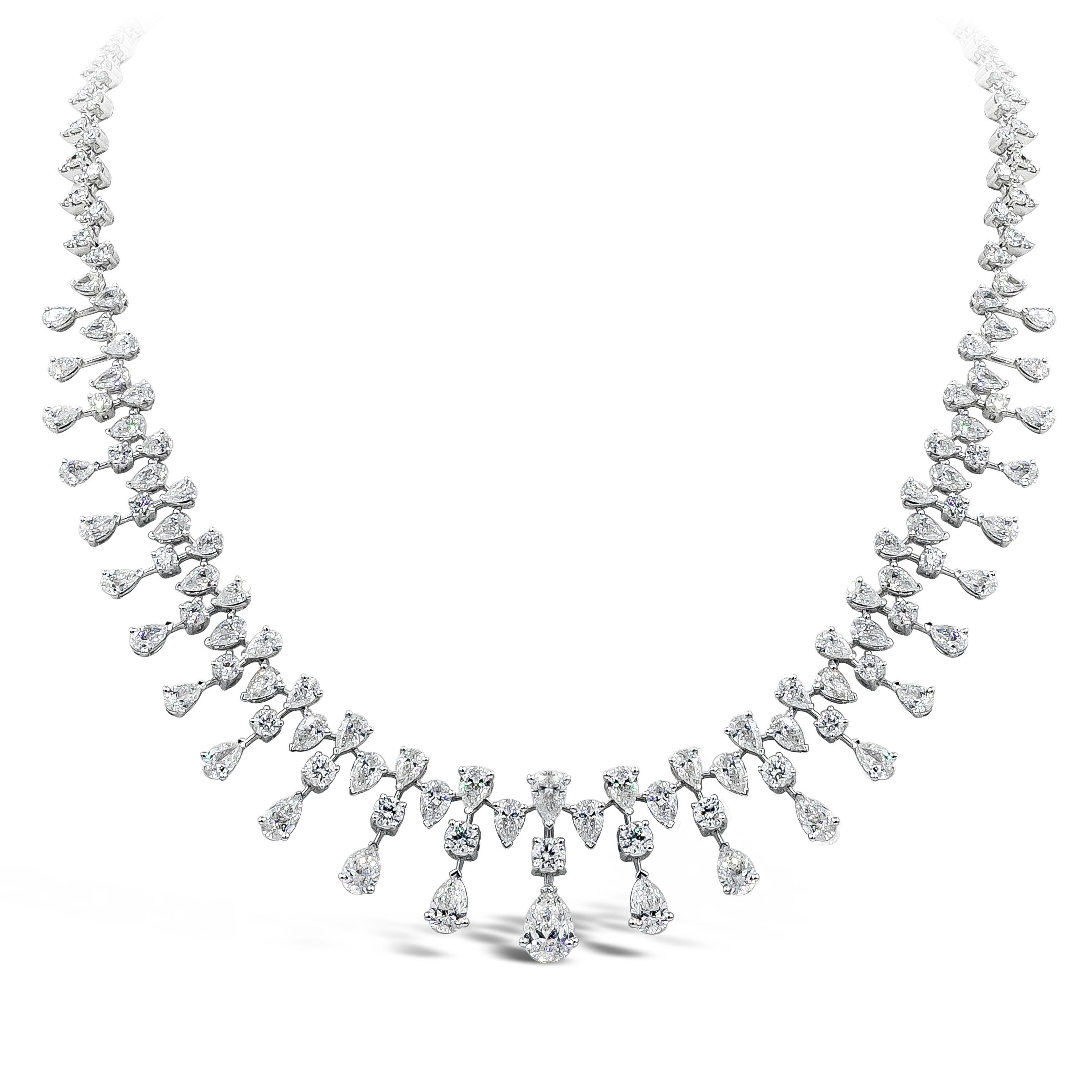 A gorgeous, important and intricately designed necklace showcasing round and pear shaped diamonds weighing 25.60 carats total. Each diamond fringe graduates in size as it gets to the center of the necklace and is spaced by graduating pear shaped