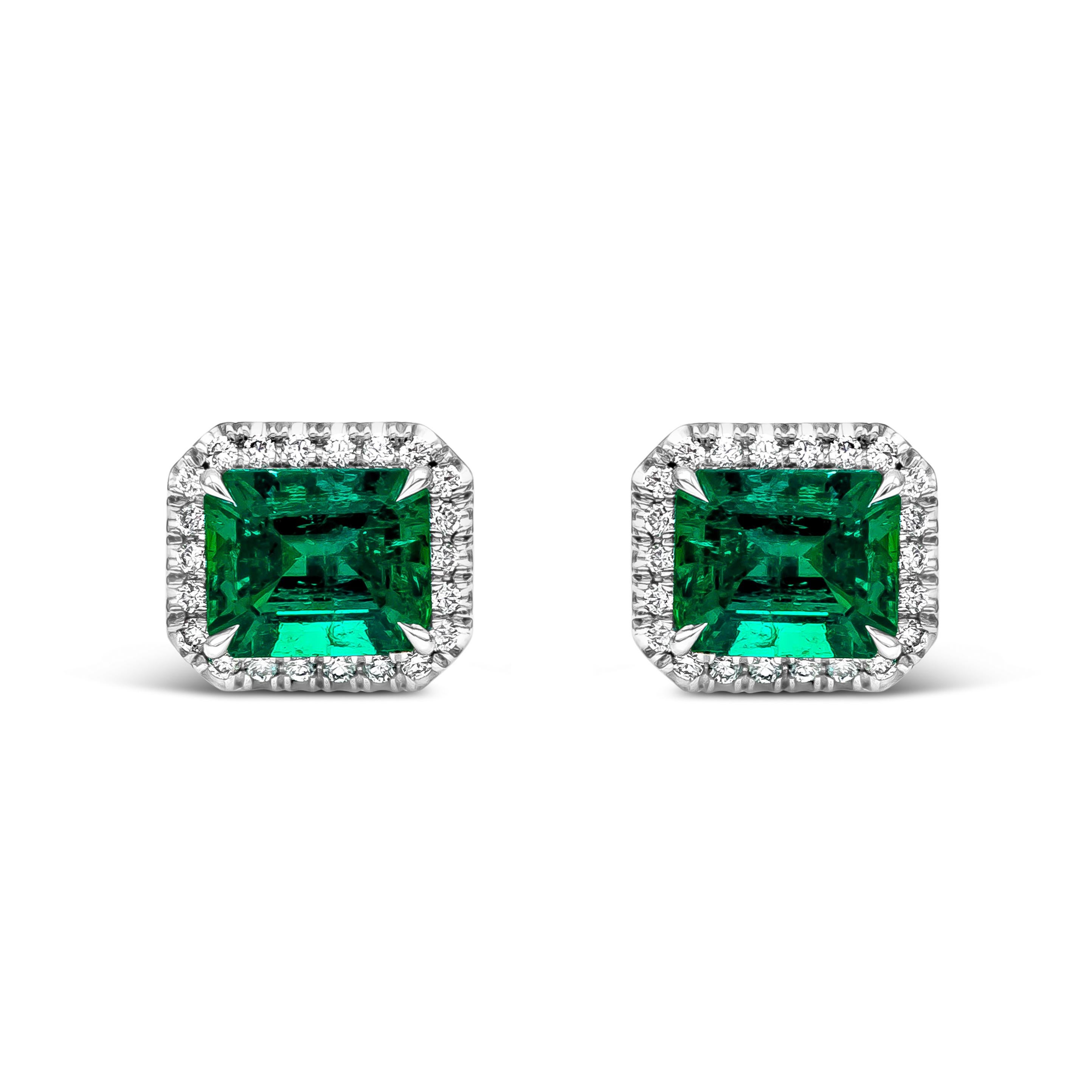 This elegant pair of stud earrings showcases two emerald cut Colombian Muzo Emerald weighing a total of 2.41 carats. Each emerald is surrounded by a row of brilliant round diamonds weighing 0.19 carats total, F Color  and VS in Clarity. Made with