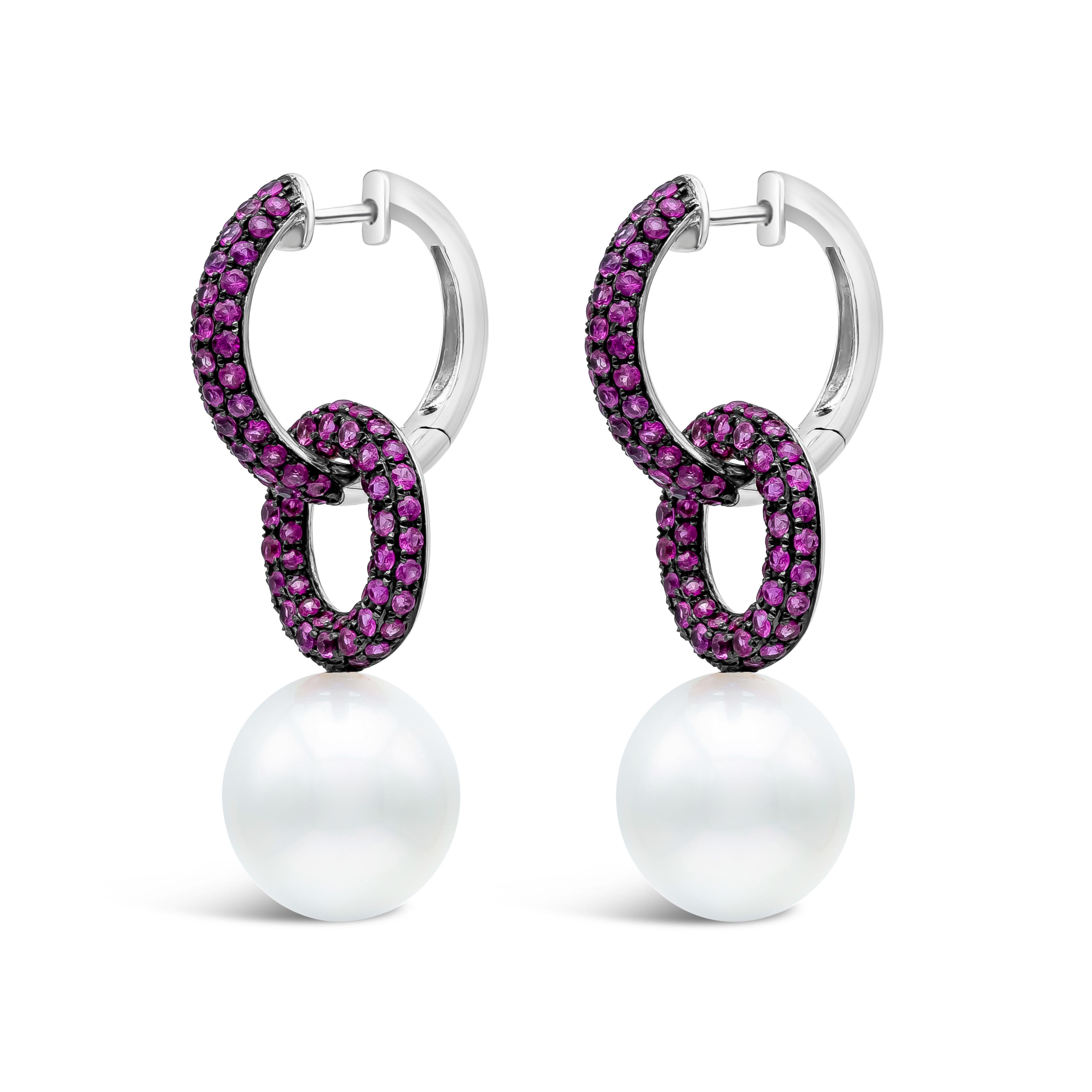 This uniquely designed double hoop link earrings is showcasing 12-13mm South Sea Pearls. It has 192 pieces of pink sapphires weighing 2.70 carats total. Upper Hoops are elegantly detachable and can wear as a single hoop earrings. Made with 18K White