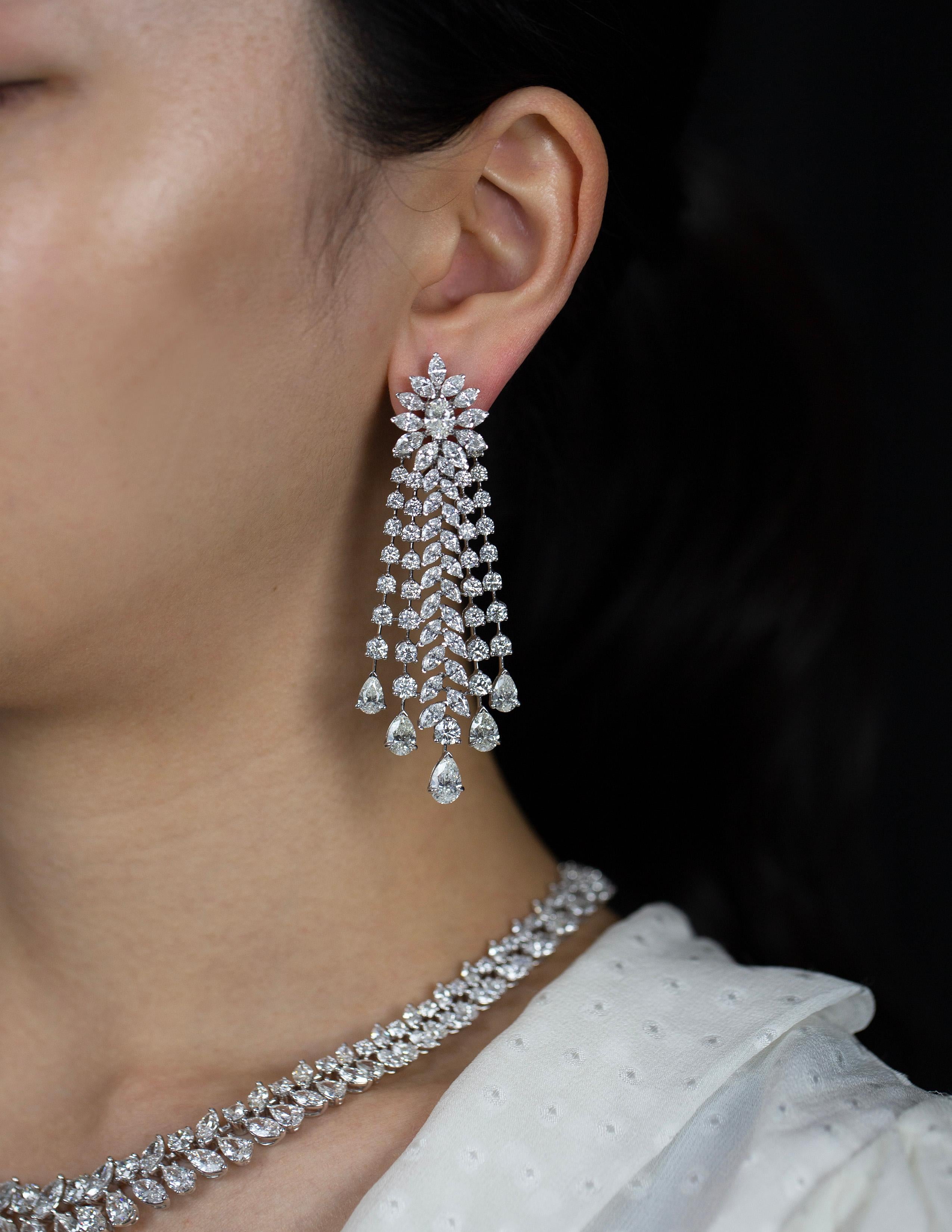 Elegantly made chandelier earrings featuring 140 pieces mixed brilliant round, pear, marquise shape diamonds weighing 27.01 carats total. Set in an intricate and sophisticated fringe chandelier design made in 18k white gold.