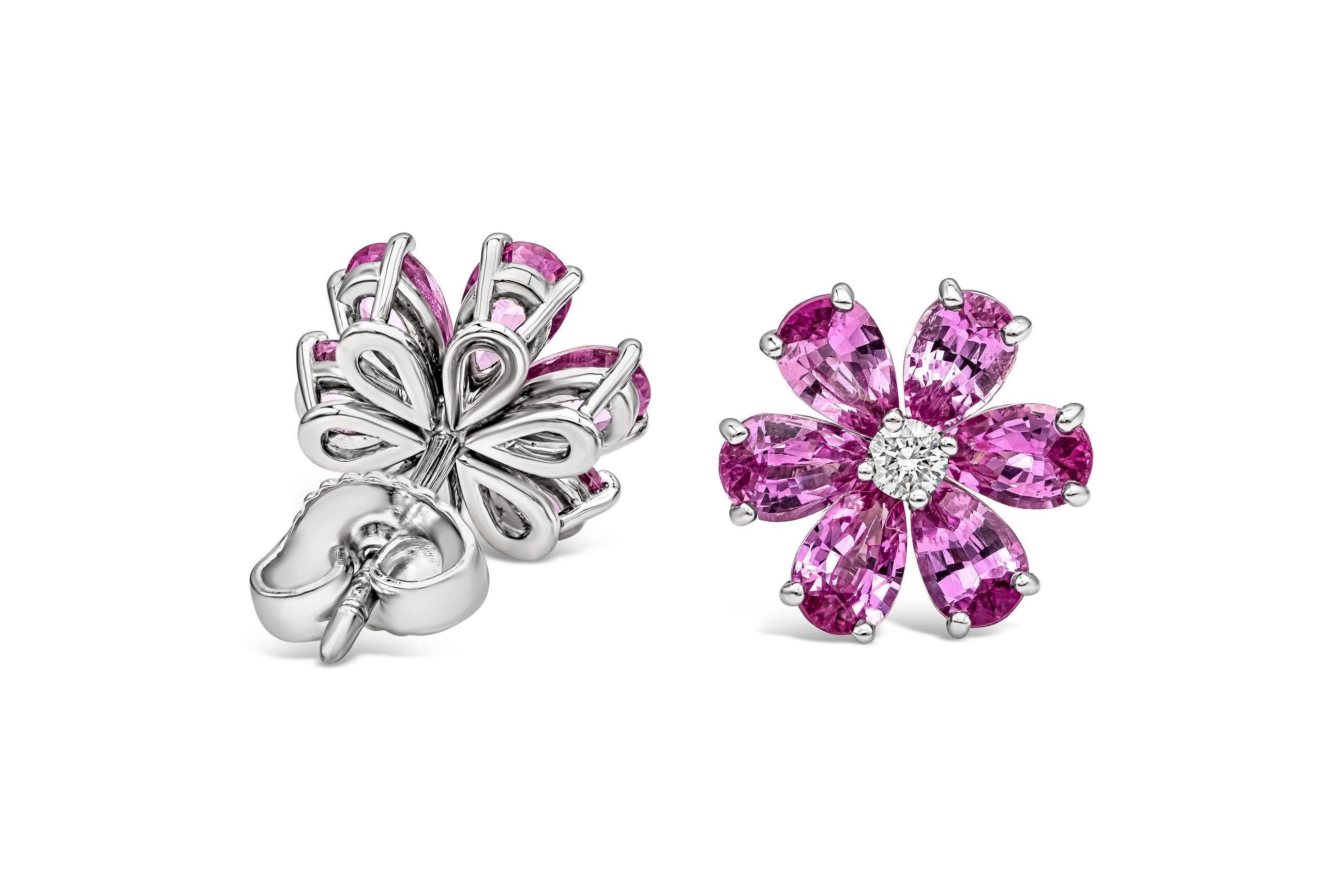 A very beautiful pair of stud earrings featuring a round brilliant diamond center, accented with color-rich pear shape pink sapphires set in a floral motif. Made in platinum.

Style available in different price ranges. Prices are based on your