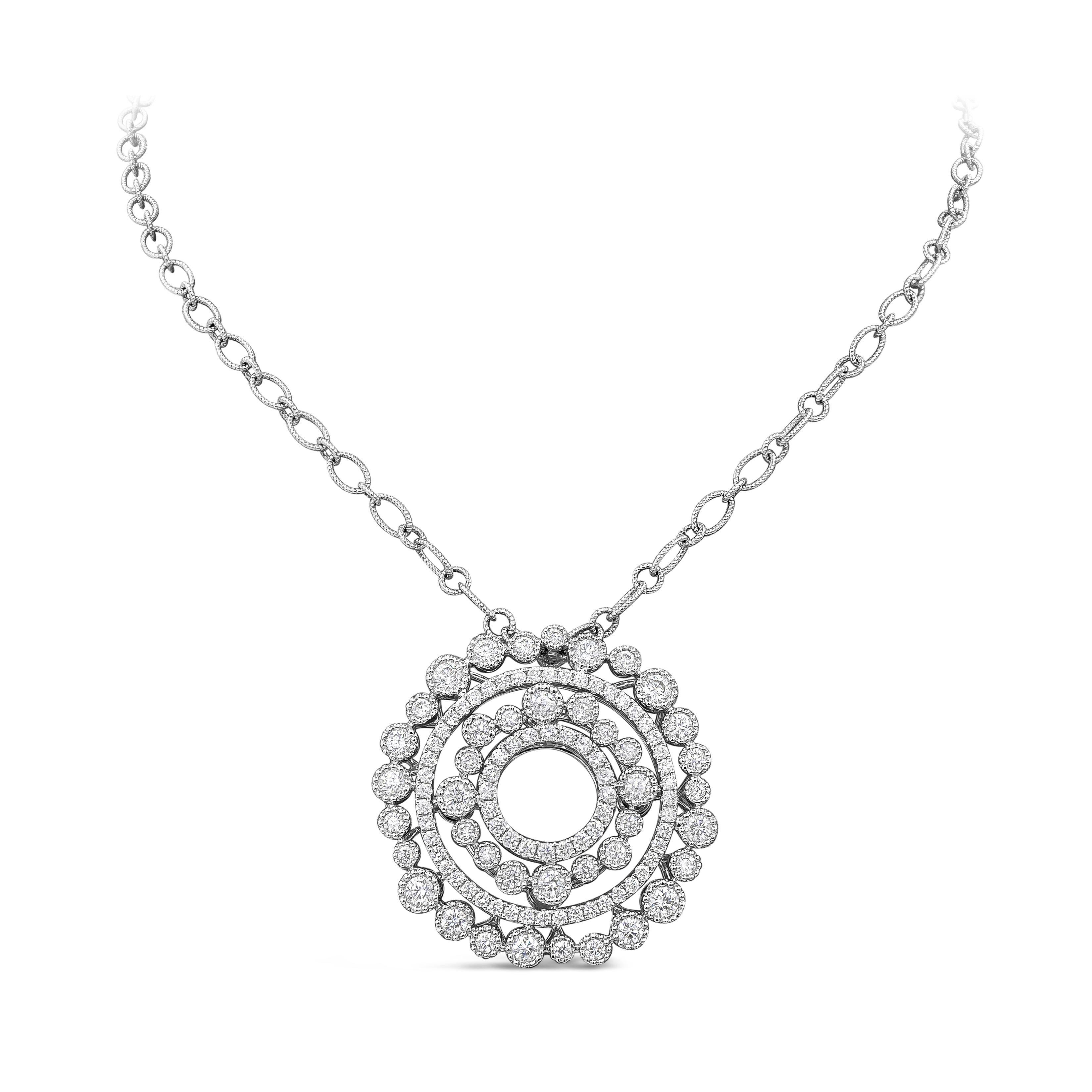 A fashionable and versatile pendant necklace showcasing a four rows of round brilliant diamonds set in a concentric open-work circle design made in 18k white gold. Finished with milgrain edges and diamonds weigh 2.94 carats total. Attached to a 20