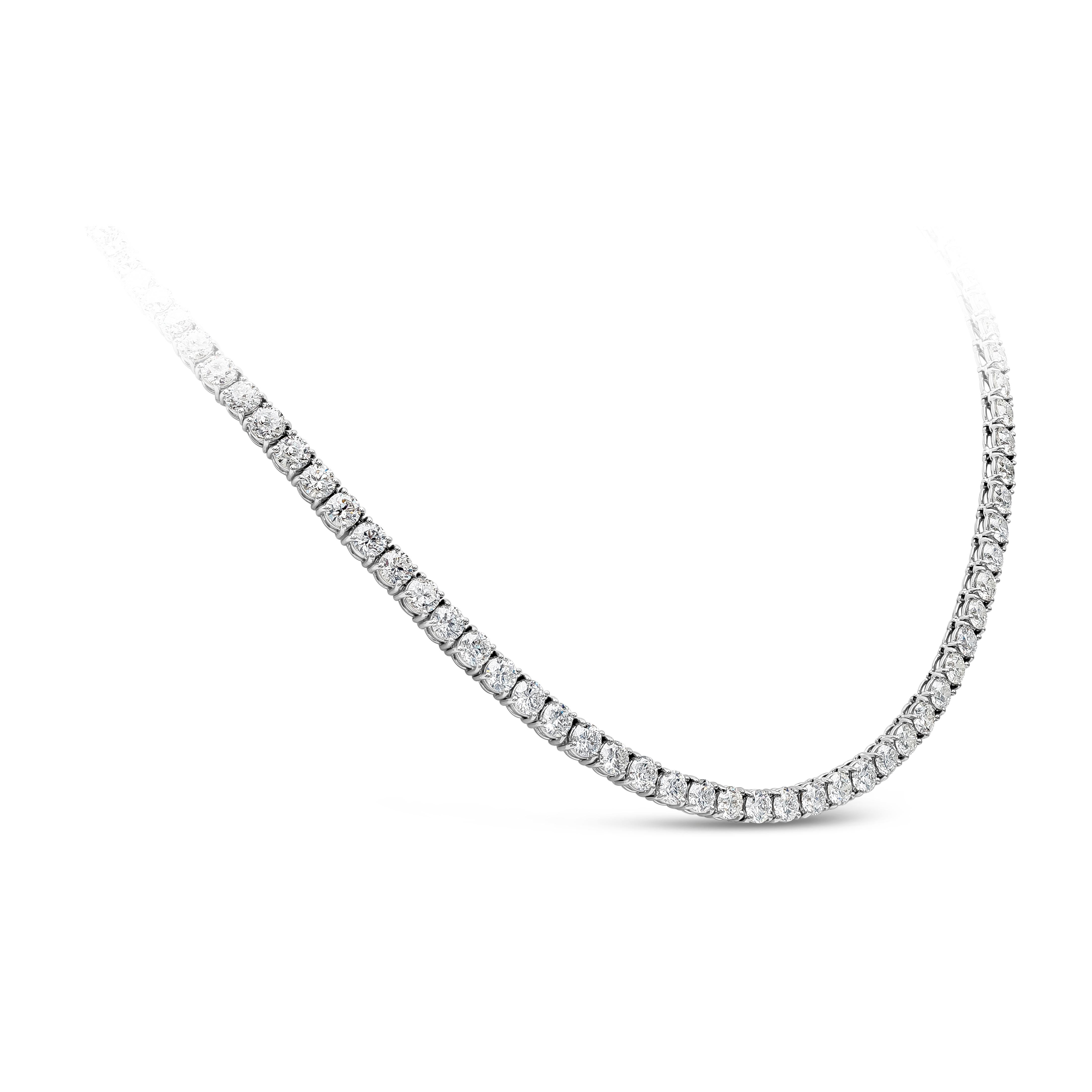 A simple and elegant tennis necklace showcasing a row of round brilliant diamonds weighing 29.43 carats total, F-G color and SI2-I1 in clarity, set in a classic four prong basket setting. Finely made in a polished 18K white gold mounting and 17
