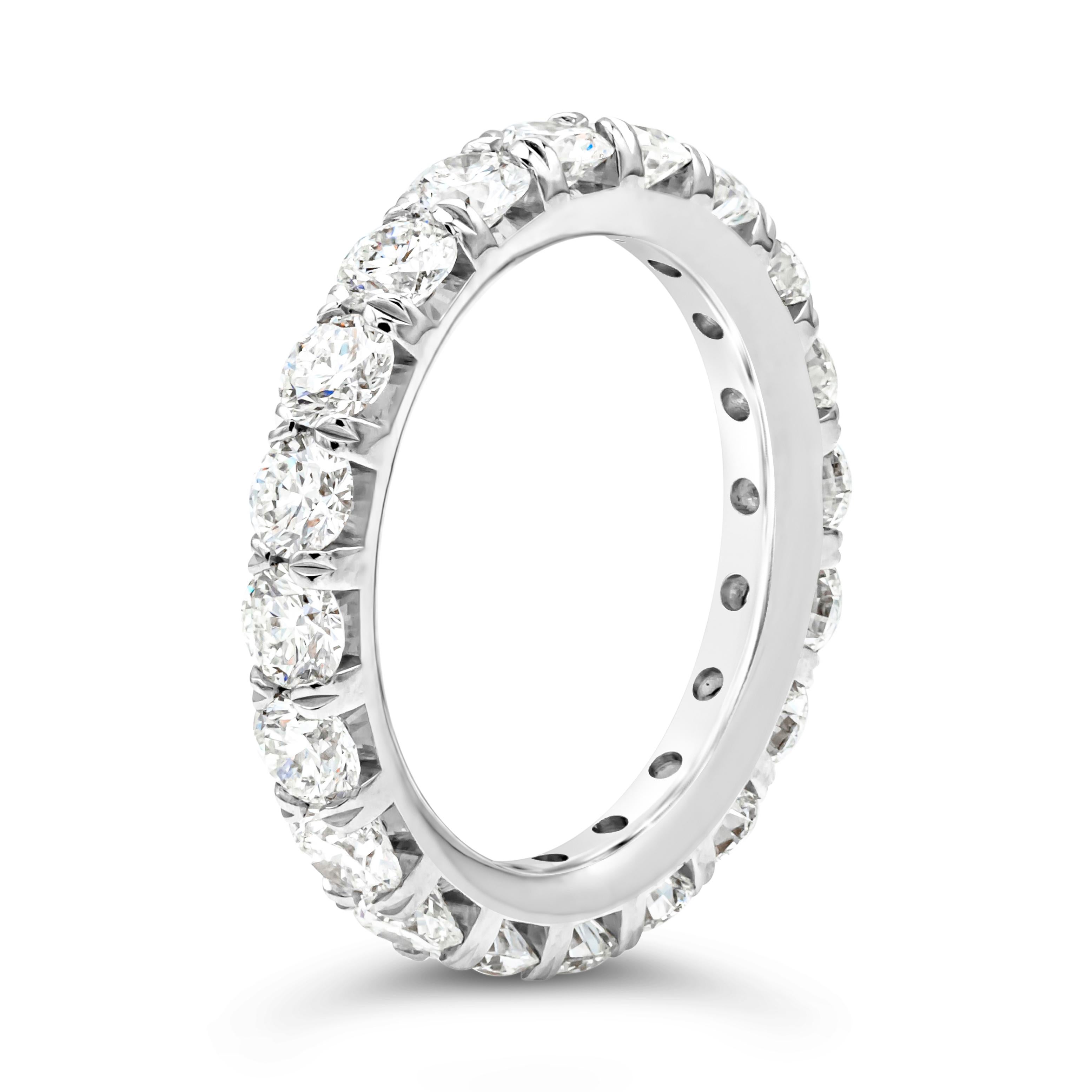 This classic eternity wedding band showcases a line of 20 brilliant round cut diamonds weighing 2.95 carats total, G color and VS in clarity, set in a four prong basket setting and French pave set. Finely made in platinum. Size 6.5 US resizable upon