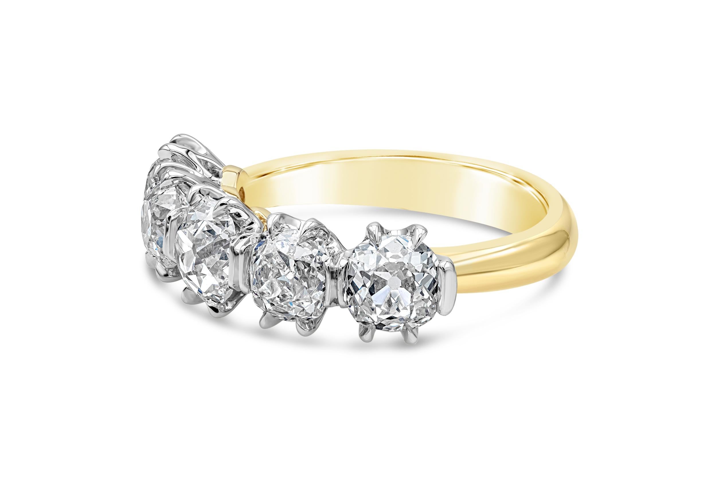 A unique and classy wedding band showcasing five (antique) old mine cut diamonds set in a six-prong platinum basket setting. Diamonds weigh 2.96 carats total, D-H Color and VS in Clarity. Finely made in 14K Yellow Gold and Size 6 US resizable upon