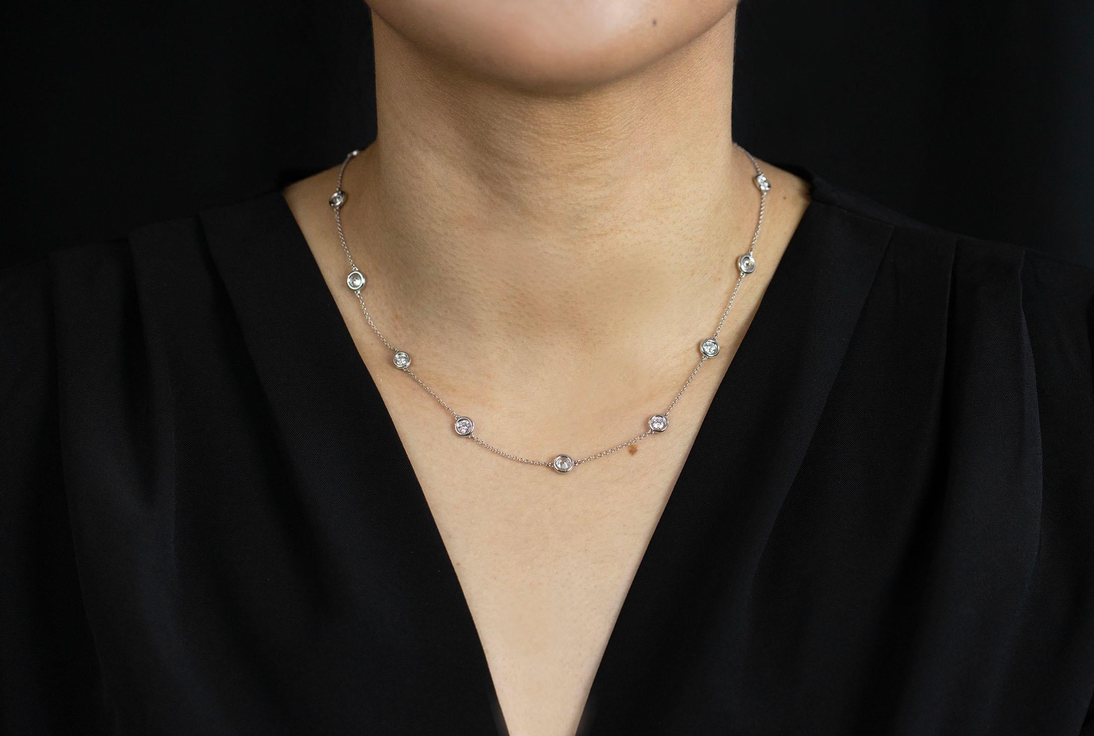 A simple diamonds by the yard necklace featuring 13 round brilliant diamonds, bezel set and evenly spaced in a 14k white gold mounting. Diamonds weigh 3.01 carats total and are approximately E color, SI clarity. Approximately 18 inches in