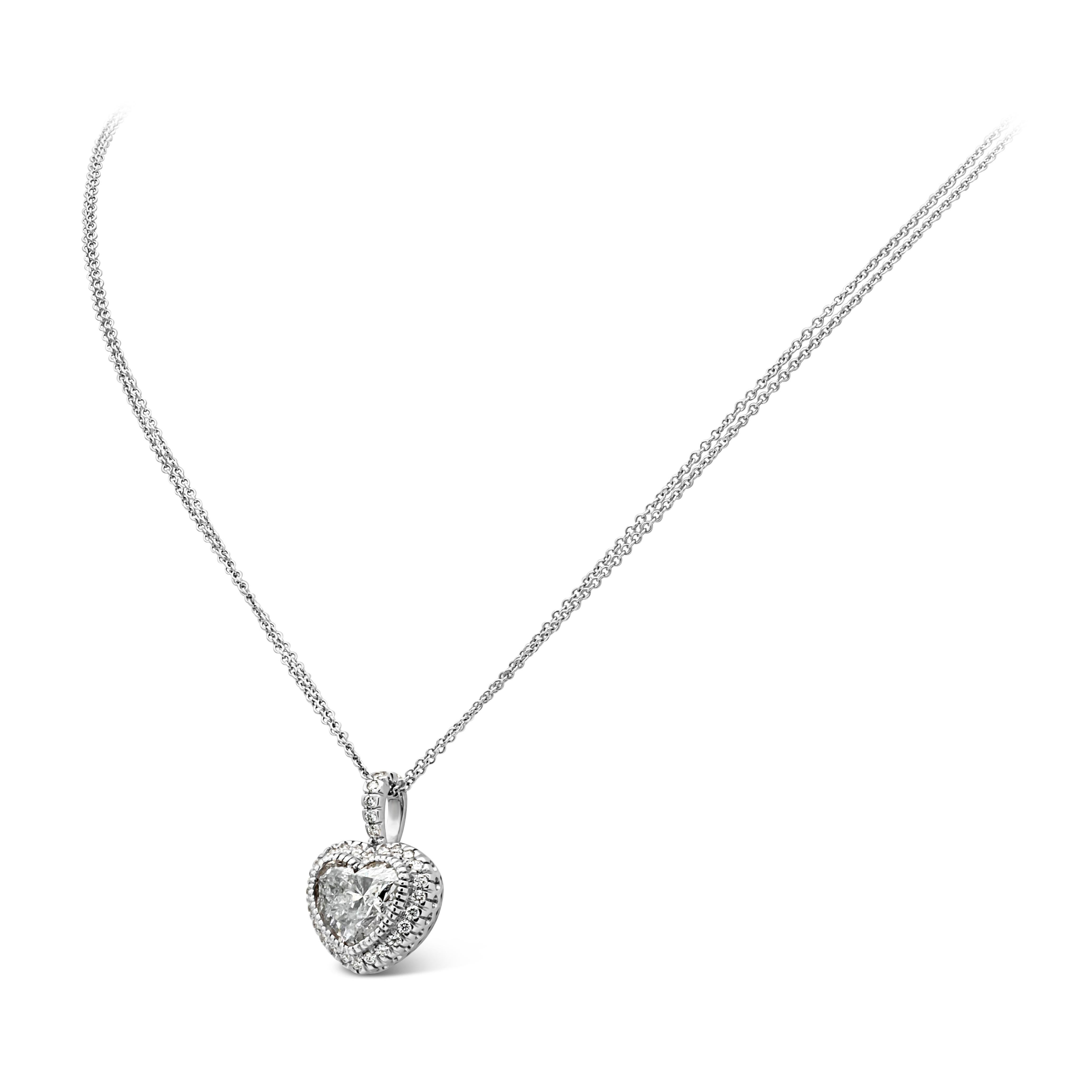 A beautiful and versatile pendant necklace showcasing a 3.05 carat heart shape diamond, E color and I2 in clarity in the center. Surrounded by a single row of brilliant round diamonds in a halo design weighing 0.31 carats total, and a diamond