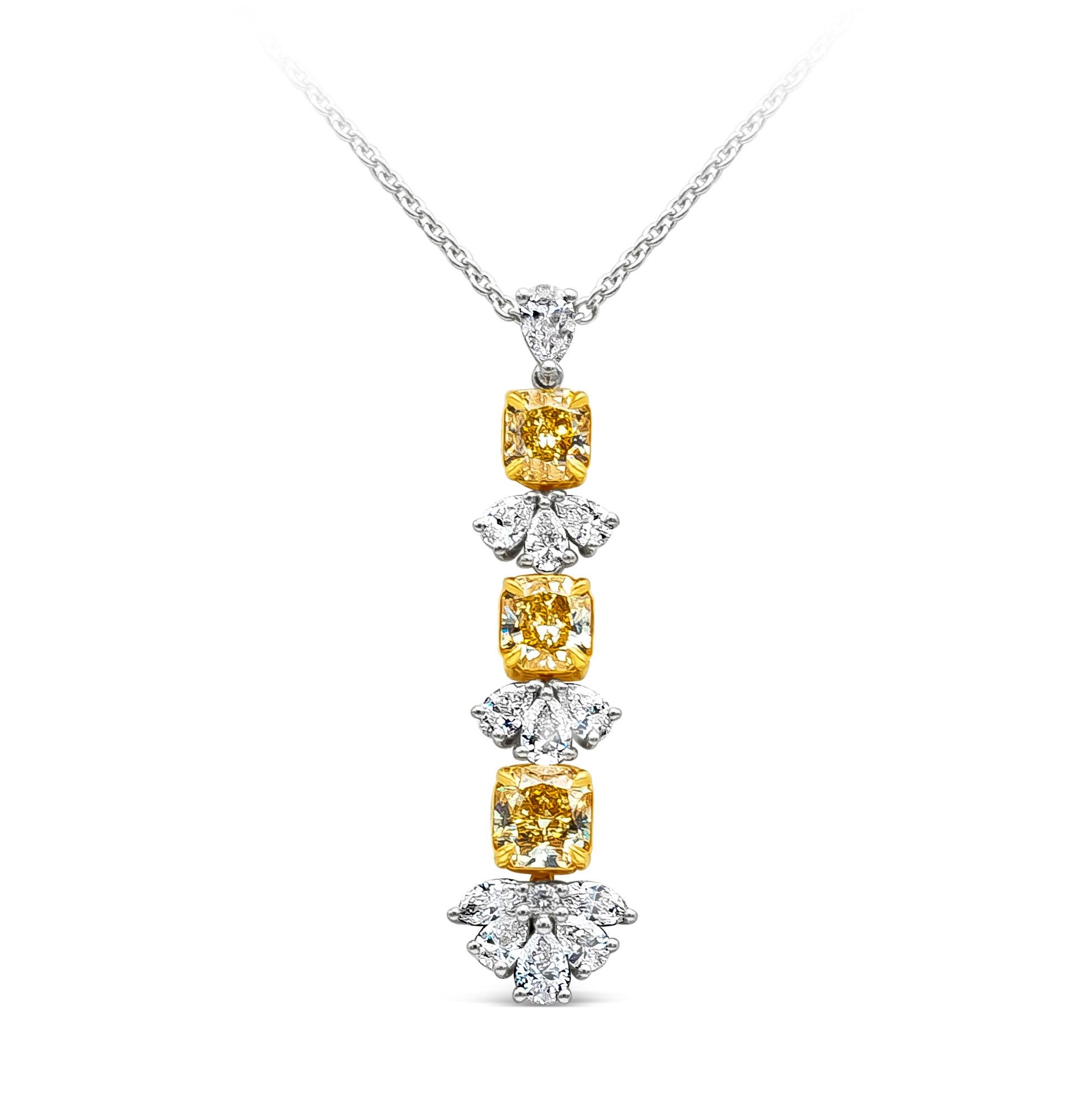 A chic drop pendant necklace showcasing 3 color-rich radiant cut fancy yellow diamonds weighing 3.13 carats total, VS in Clarity. Set on a 18K Yellow Gold basket. Each separated by mixed-cut (pear shape, marquise & round) diamonds on a drop design,
