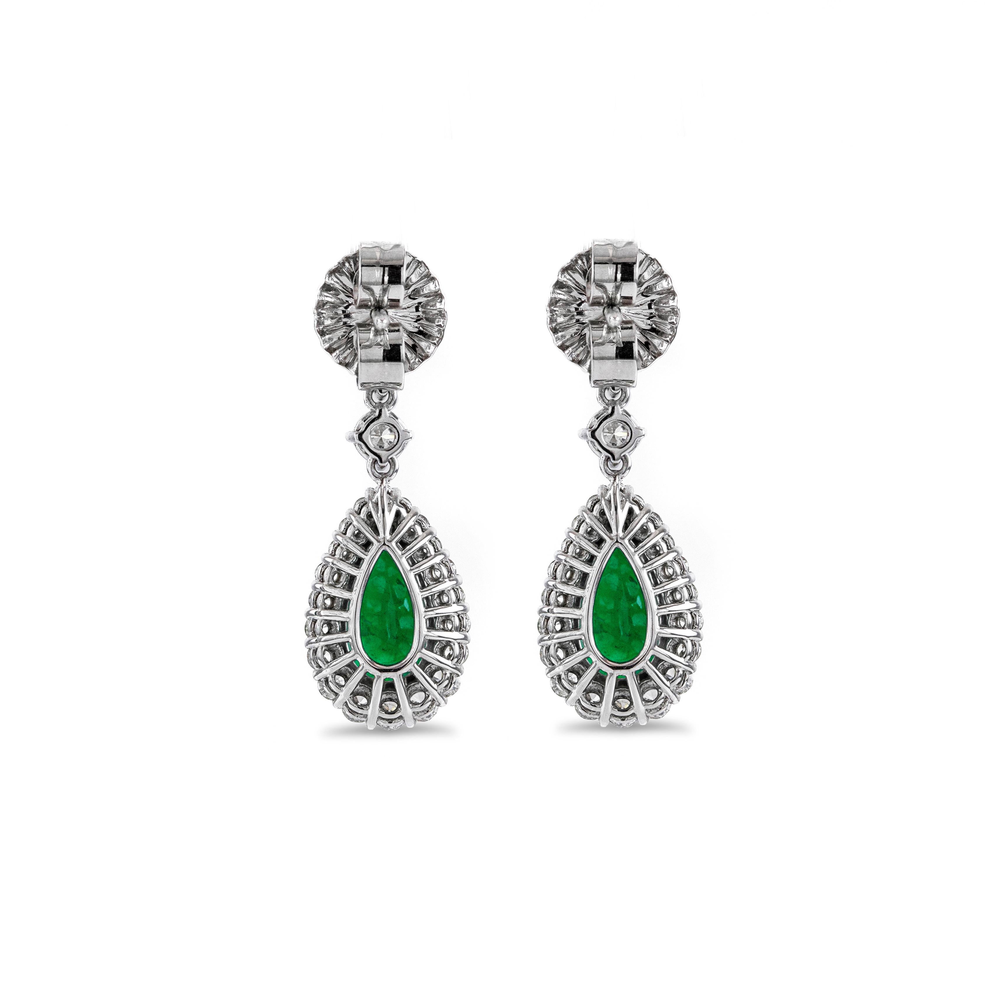 This chic and beautiful drop earrings showcases pear shape green emeralds weighing 3.37 carats total, surrounded by a single row of round brilliant diamond and suspended on graduating round brilliant diamonds. Diamonds weigh 1.58 carats total.