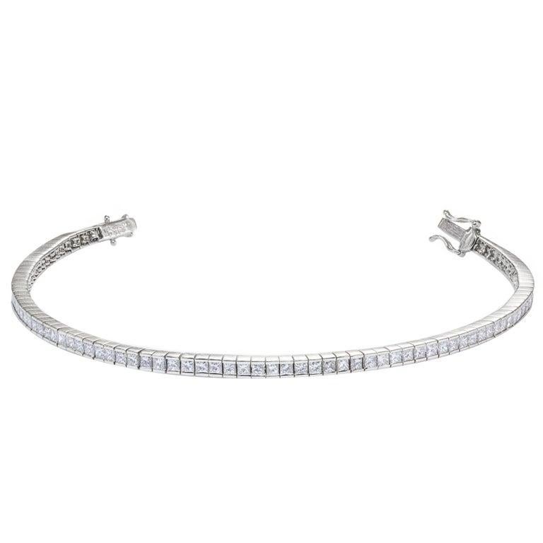 A classic tennis bracelet style showcasing 90 pieces of princess cut diamonds, weighing 3.56 carats total and approximately G color, VS in clarity. Made in 18K White Gold. 7 inches in Length and 3mm in Width.

Style available in different price