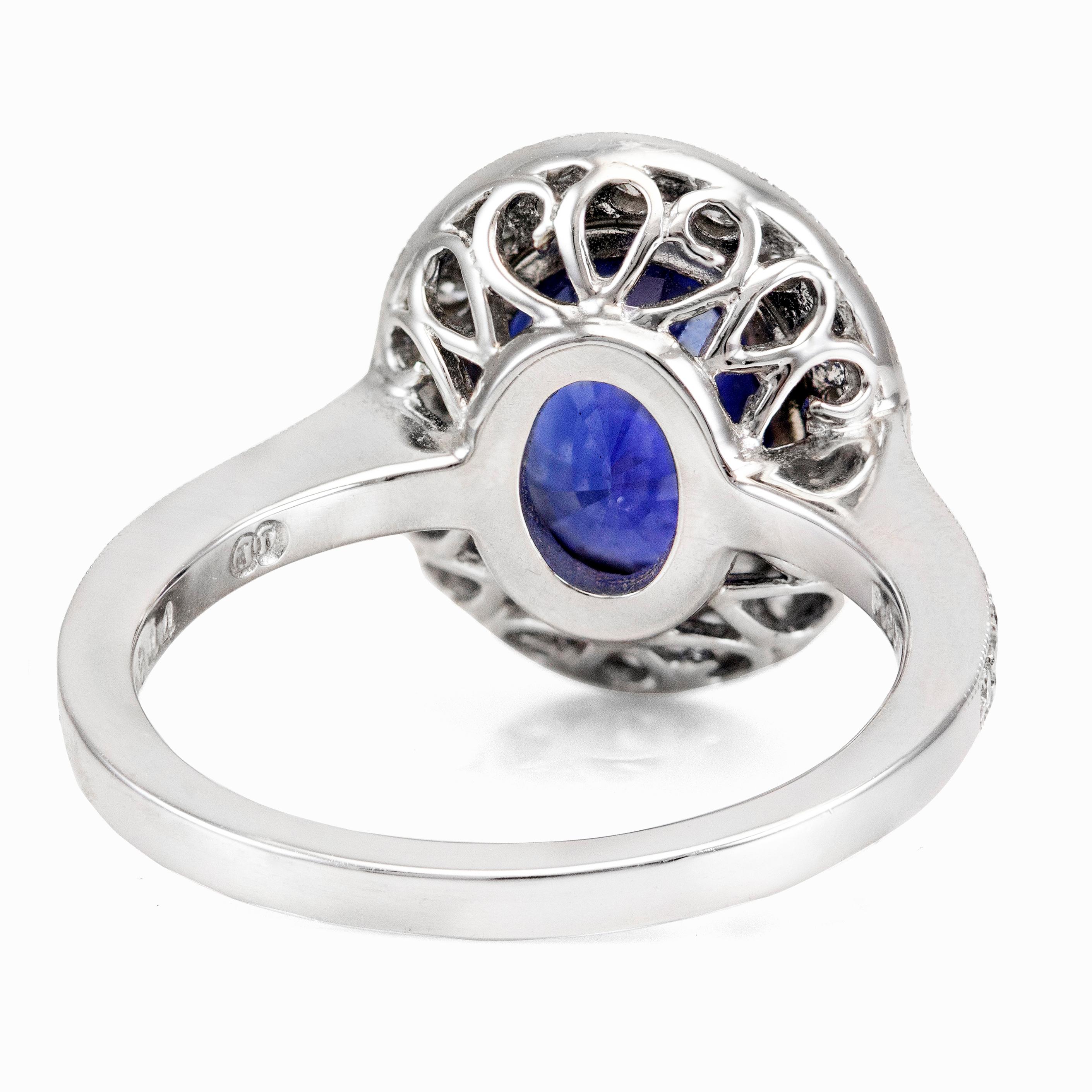 This ring features a 3.60 carats color-rich blue sapphire surrounded by a single row of brilliant round diamonds that continue to the shank of the ring. The diamonds weigh 0.53 carats total. The sapphire has a rich blue color and is eye clean. Set