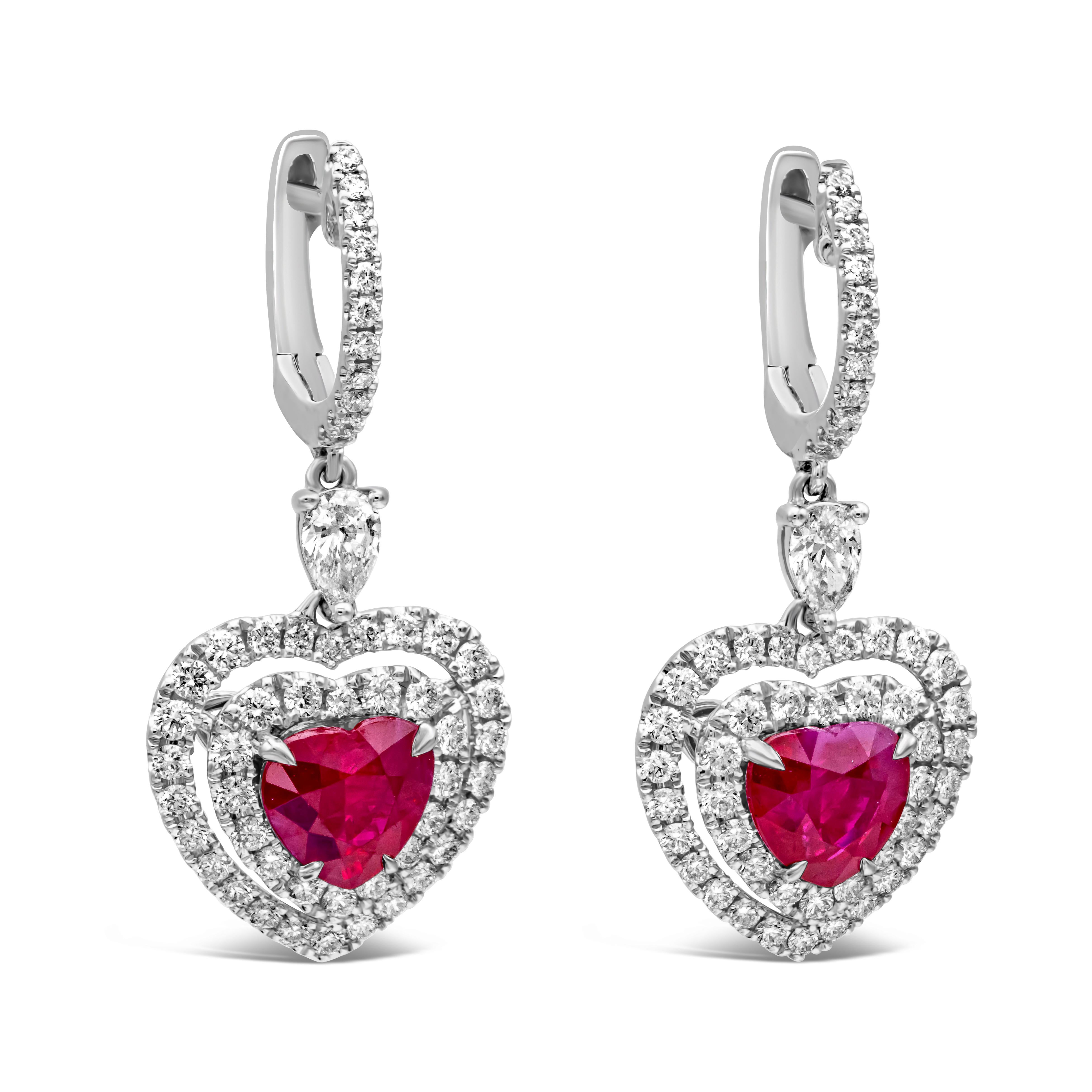 Showcasing a heart shape ruby surrounded by a double halo and hanging by a single pear shape diamond. Rubies weigh 3.67 carats total, SI in clarity. Pear shape and round diamonds weigh 1.58 carats total, F-G color, VS-SI in clarity. Perfectly made