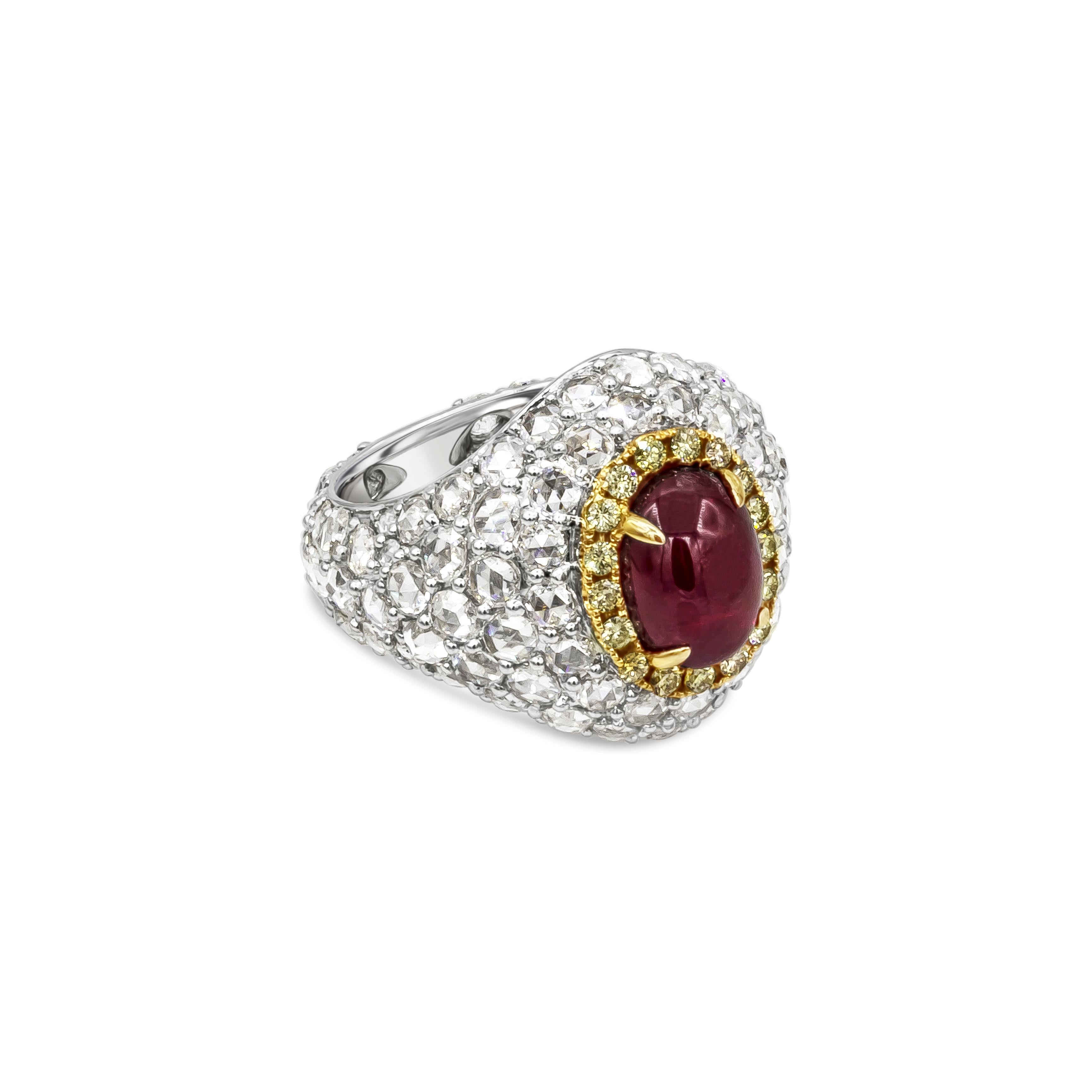 A fashionable and stunning dome cocktail ring showcasing a 3.76 carats color-rich cabochon ruby, surrounded by a single row of round brilliant yellow diamonds. Set in a polished 18k white gold ring micro-pave set with beautiful rose cut diamonds